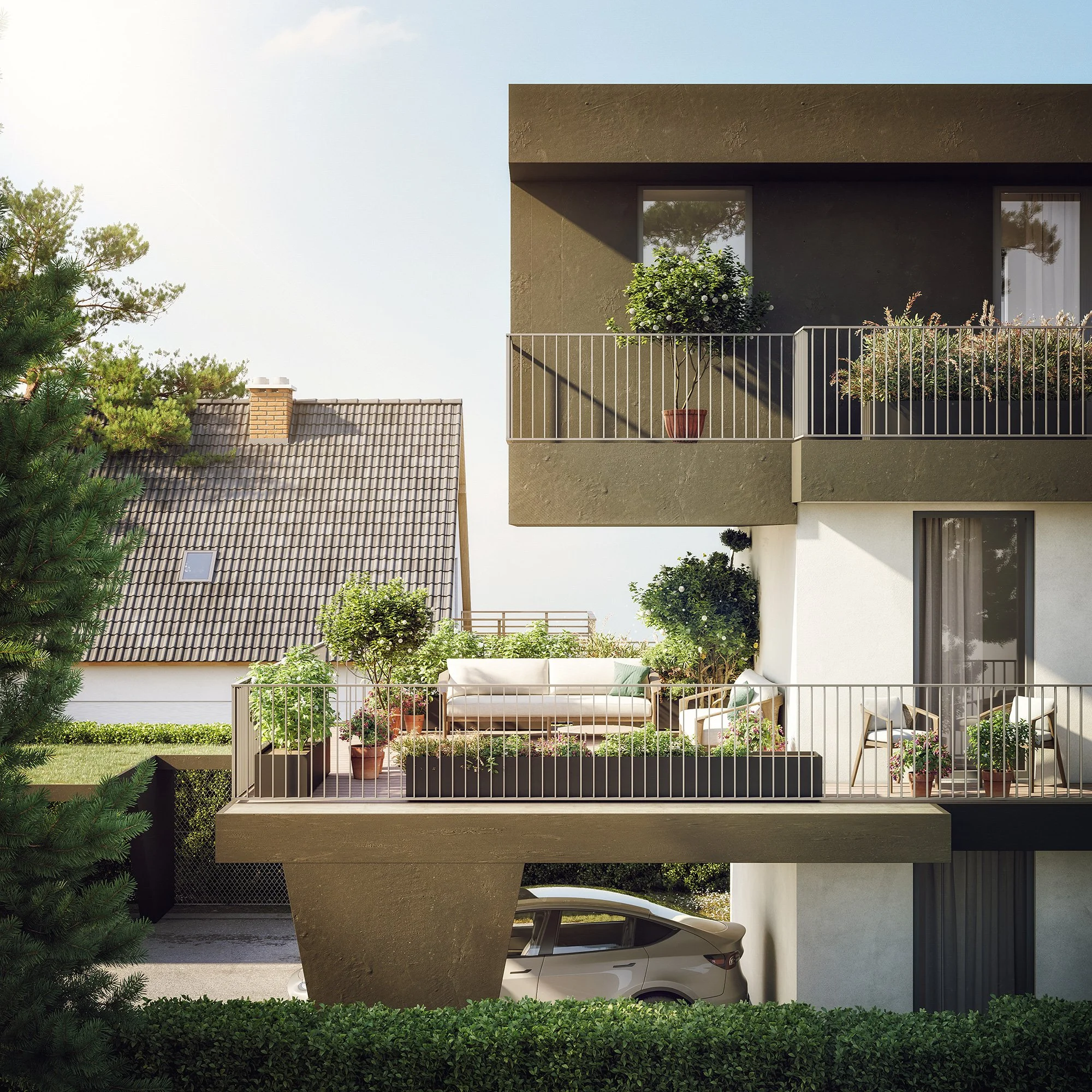 Modern residential building with large beige concrete balcony, potted plants, and glass doors. Greenery surrounds the building, with trees visible on the side and neighboring rooftops.