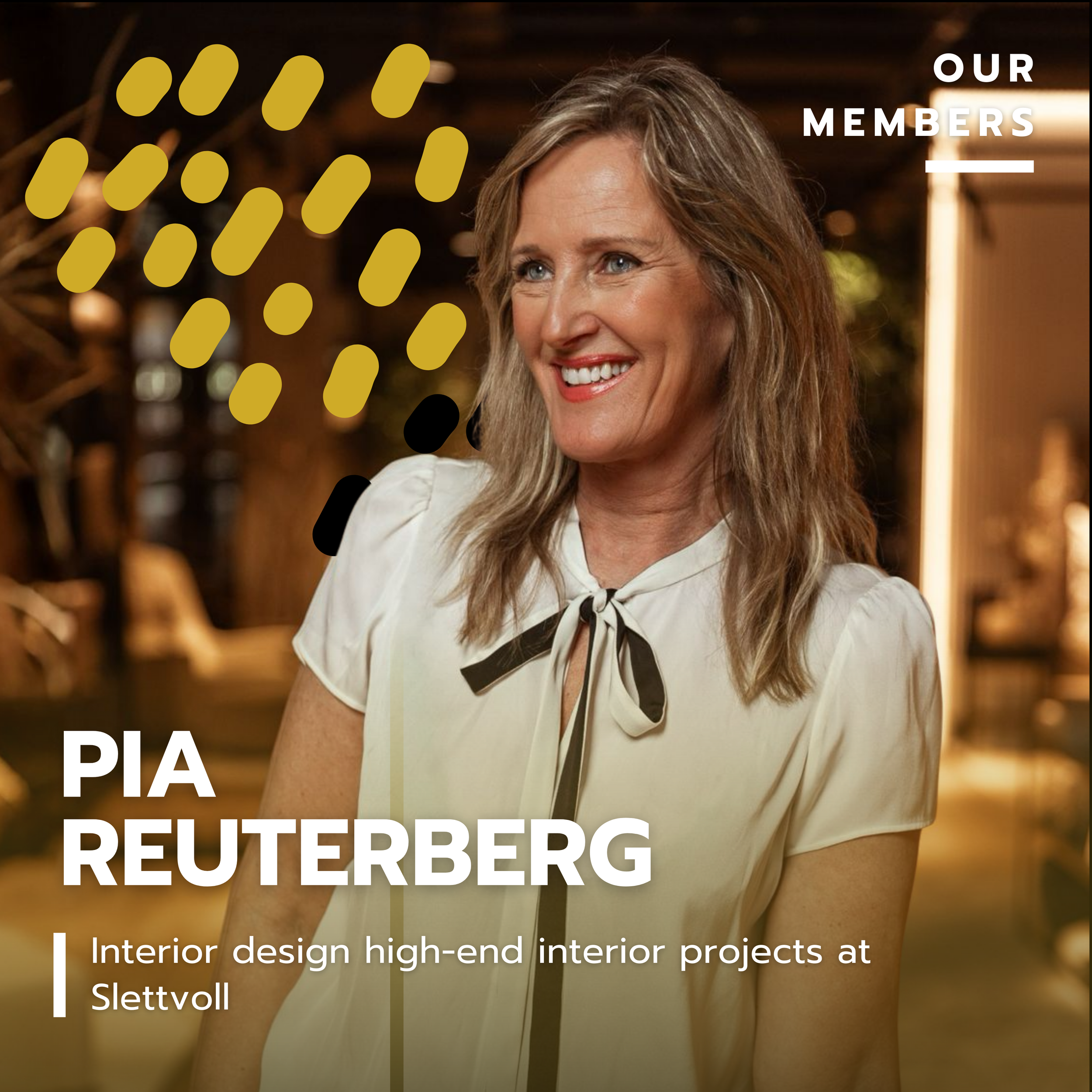 A woman with shoulder-length blonde hair wearing a cream-colored blouse with a black ribbon tie, smiling, in a warmly lit indoor setting with decorative elements in the background.