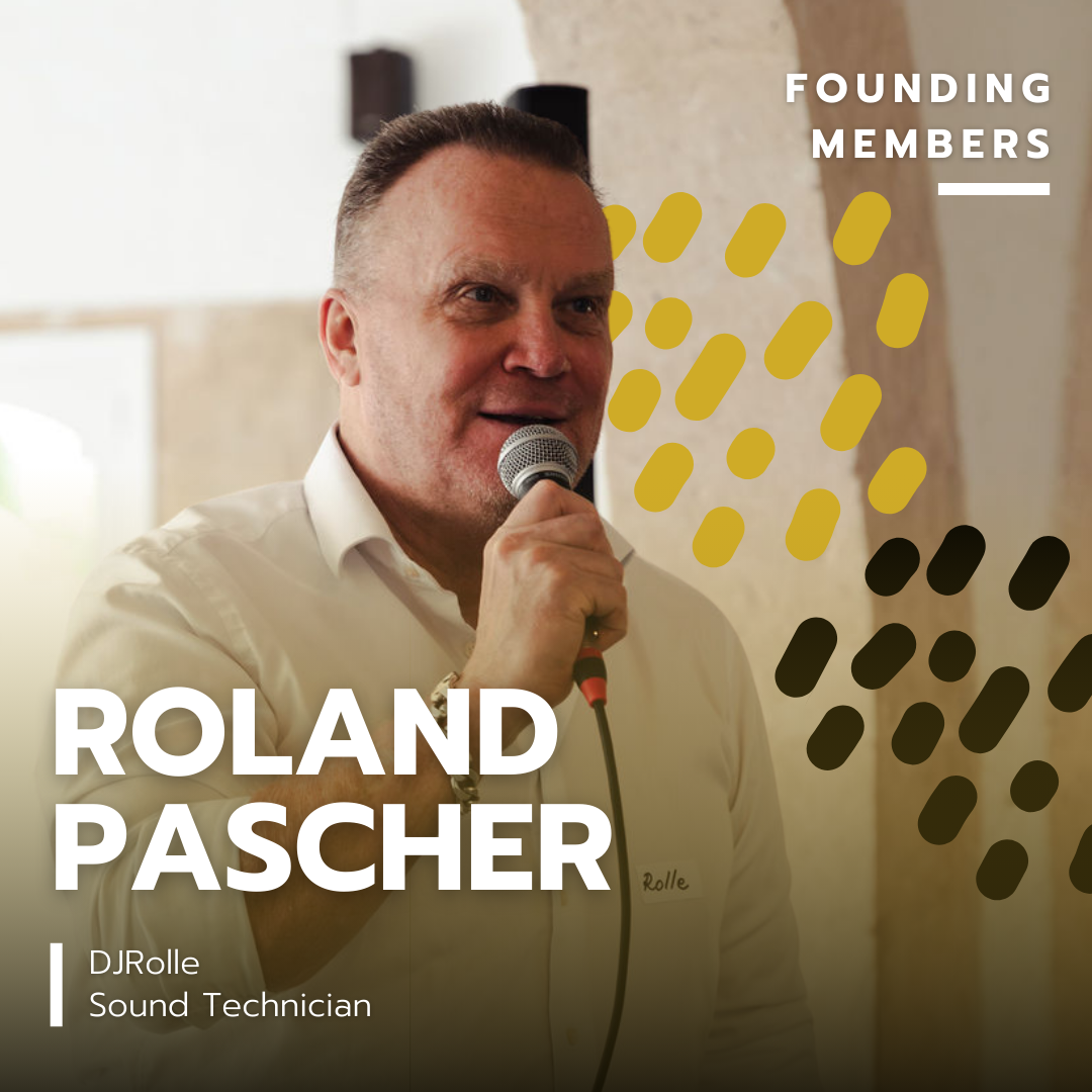 Man speaking into a microphone at an indoor event, with text overlay indicating he is Roland Pascher, sound technician, and founding member.