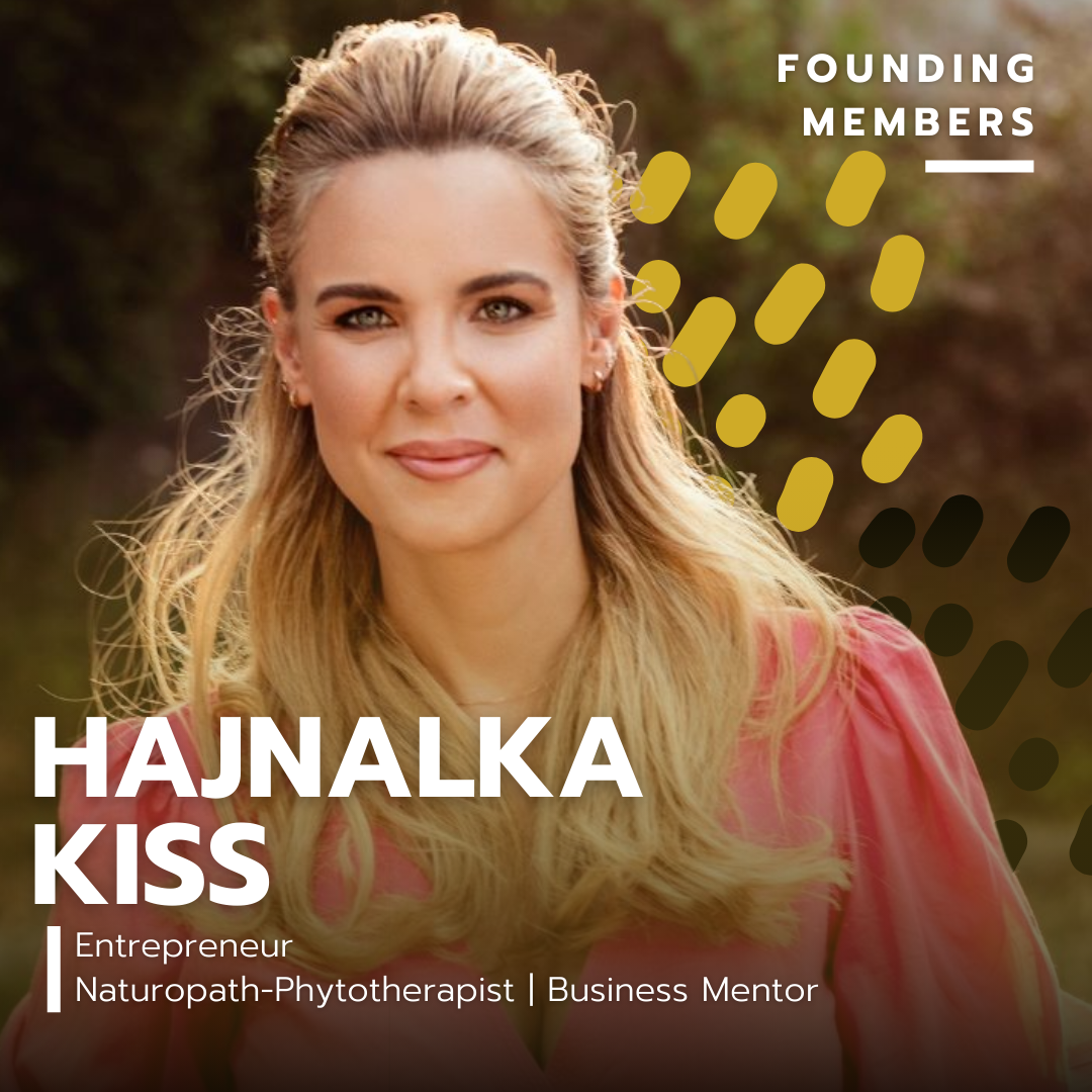 A woman with blonde hair and green eyes, wearing a pink top, outdoors with blurred trees in the background.