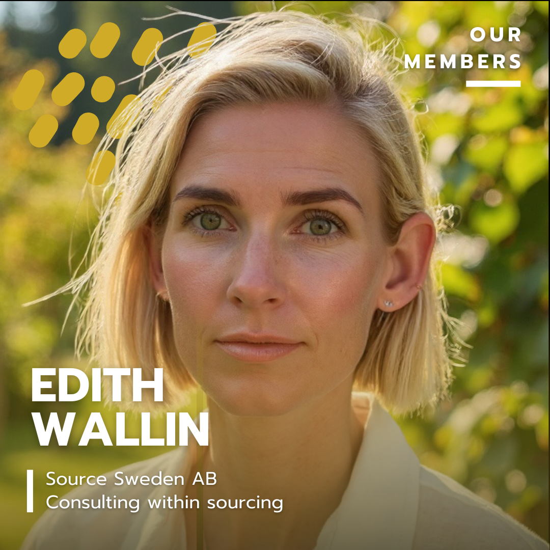 Close-up portrait of a blonde woman outdoors with green foliage in the background, looking directly at the camera.