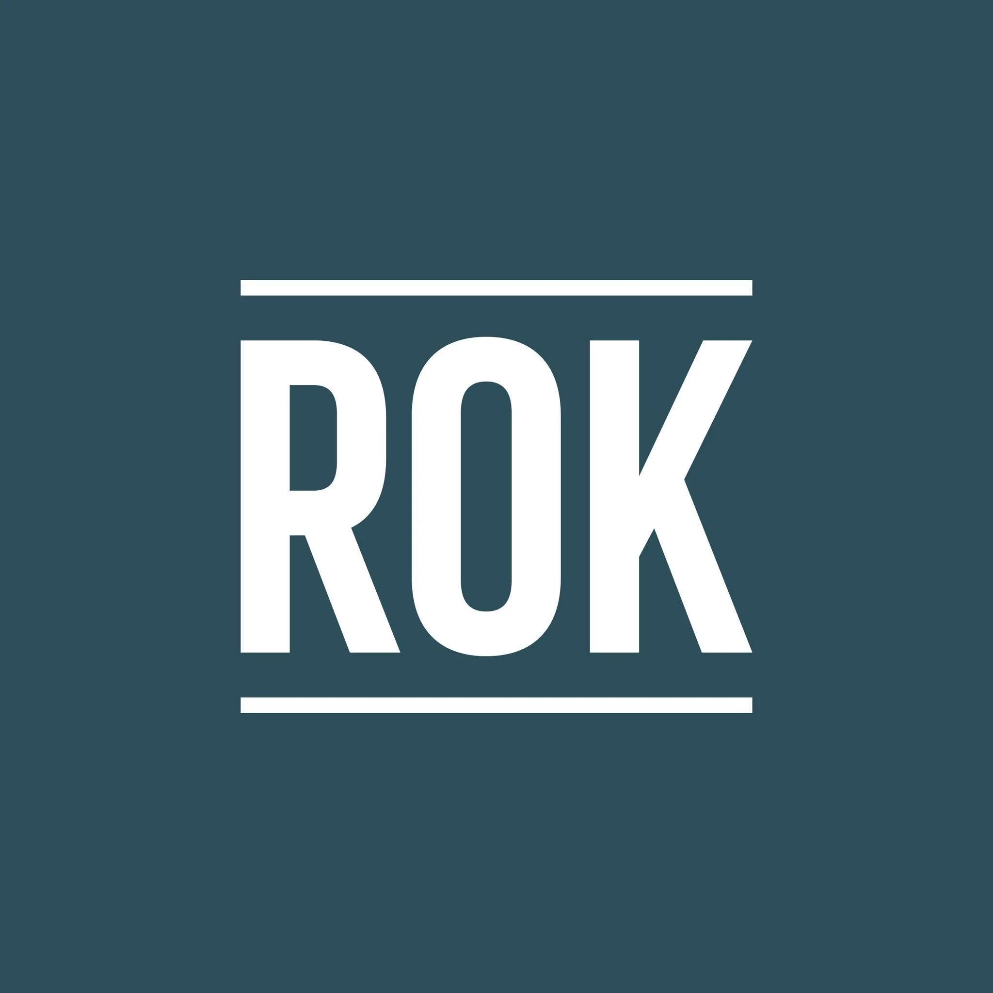 Logo with the word 'ROK' in white capital letters, outlined and underlined, on a dark teal background.