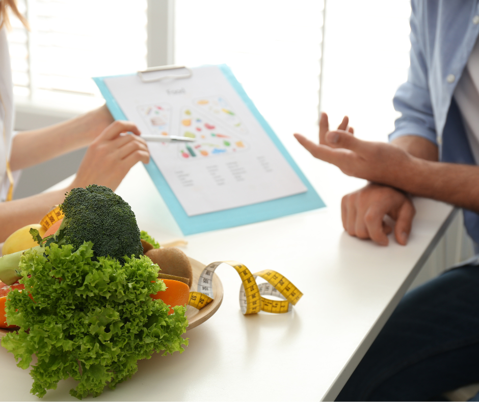 A consultation about healthy eating with vegetables, a measuring tape, and a nutrition chart.
