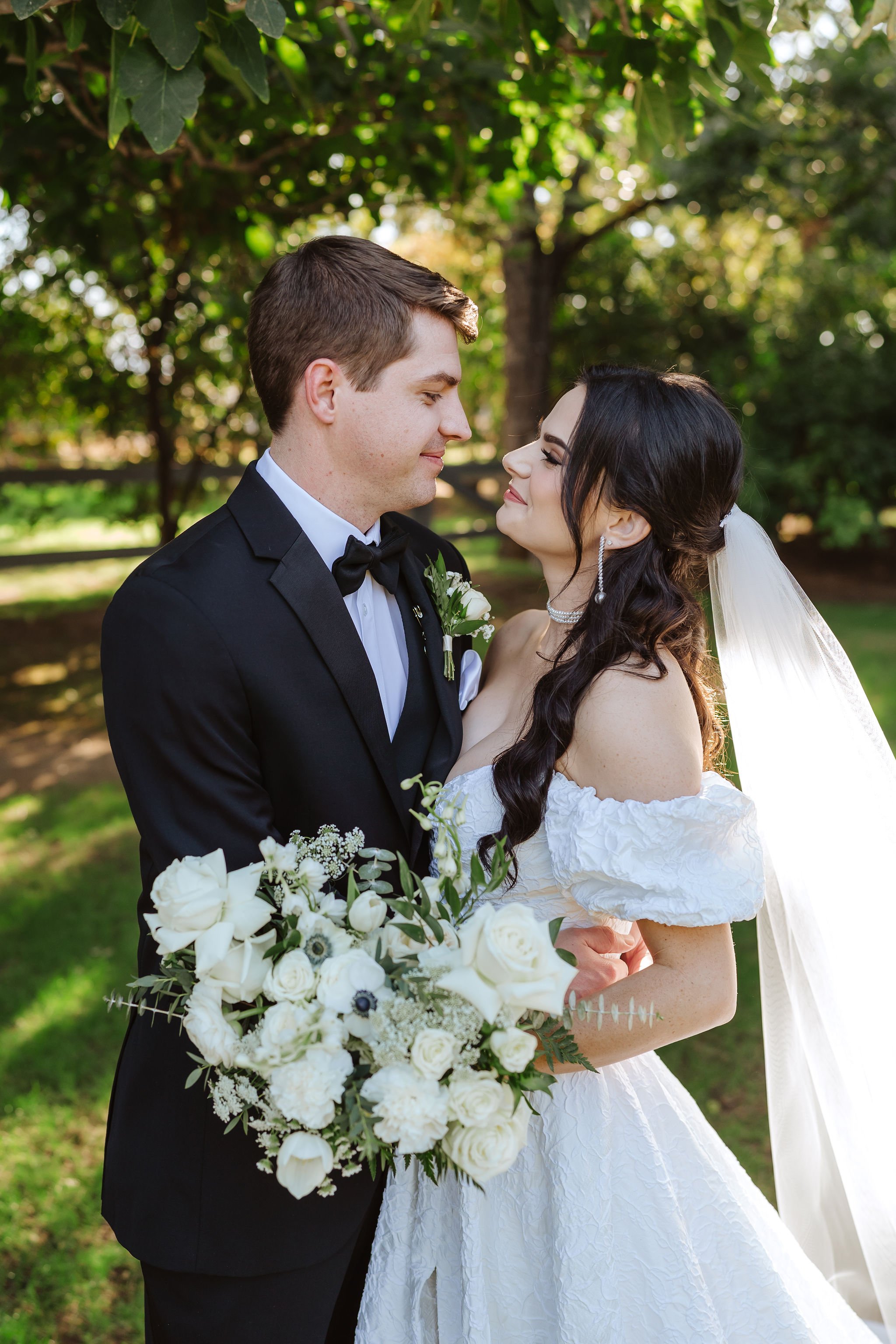 Sierra and Alex holding an organic white and green bridal bouquet at their Venue at the Grove wedding.