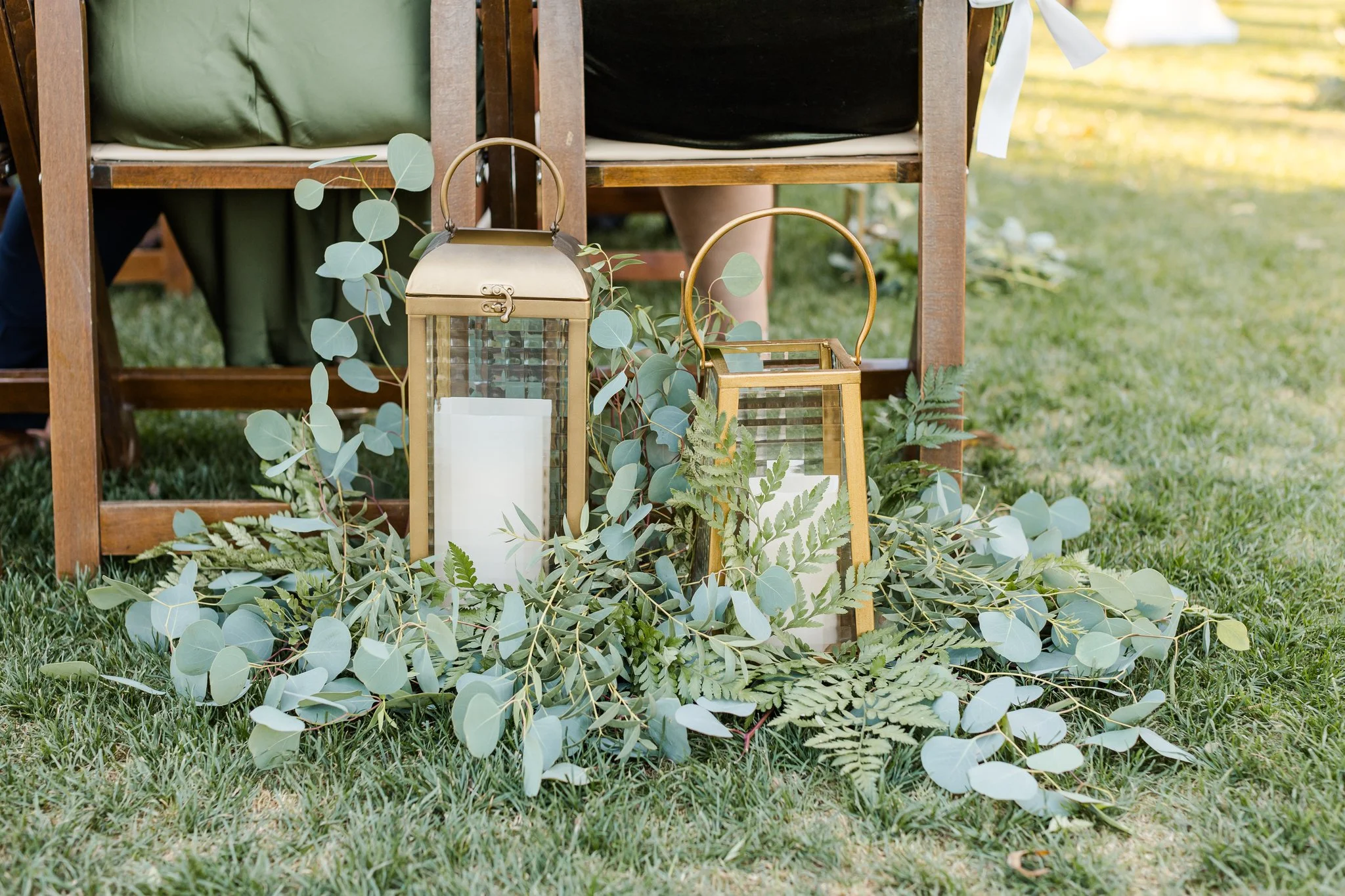Wedding reception detail with greenery, candles and warm garden-inspired décor at Venue at the Grove.