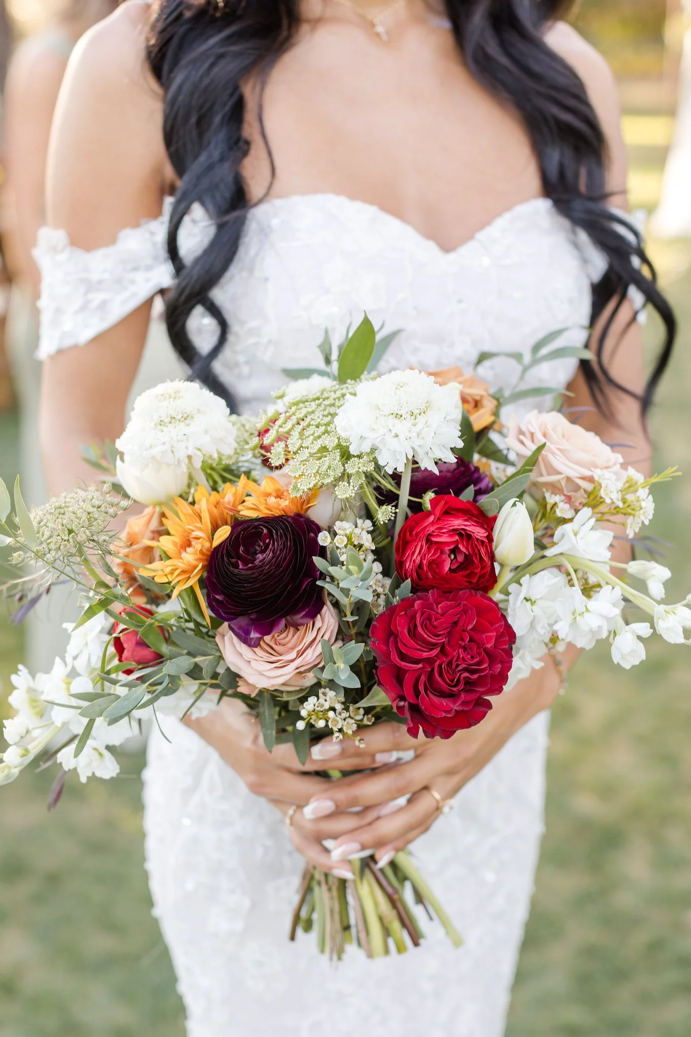 Fall bridal bouquet featuring burgundy, rust, peach and cream flowers with organic greenery.