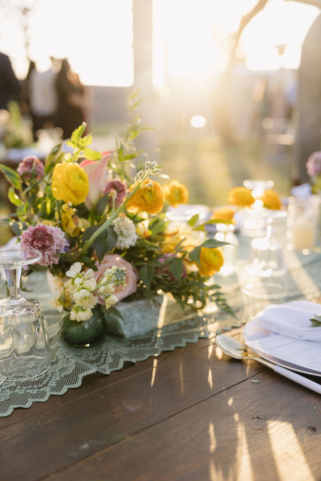 Backyard wedding ceremony decorated with colorful garden-inspired floral arrangements and bright organic flowers.