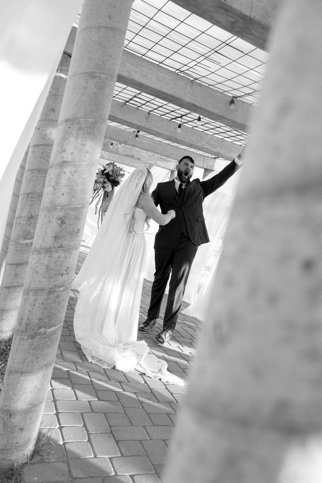 Black and white portrait of newlyweds at an intimate backyard wedding.