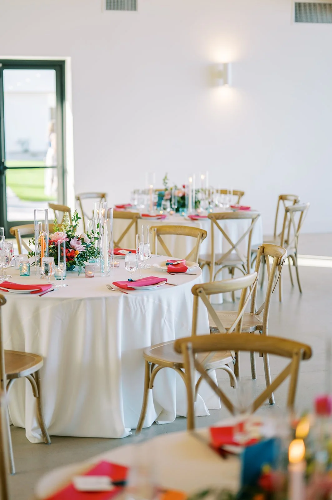 Bright wedding reception with colorful table details, gold chairs and modern floral accents at Desert View.