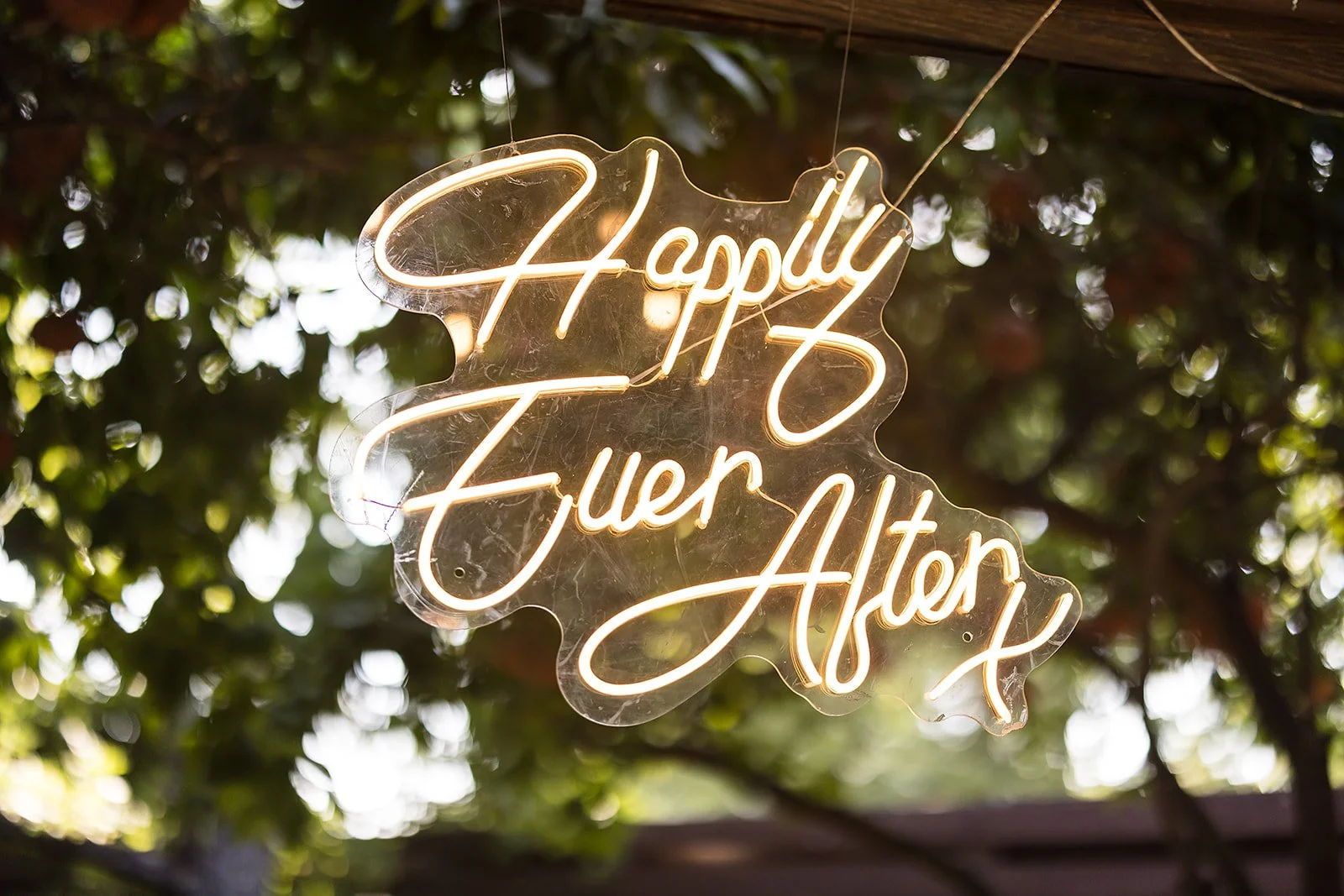 Happily ever after wedding sign surrounded by romantic white flowers and greenery at Venue at the Grove.