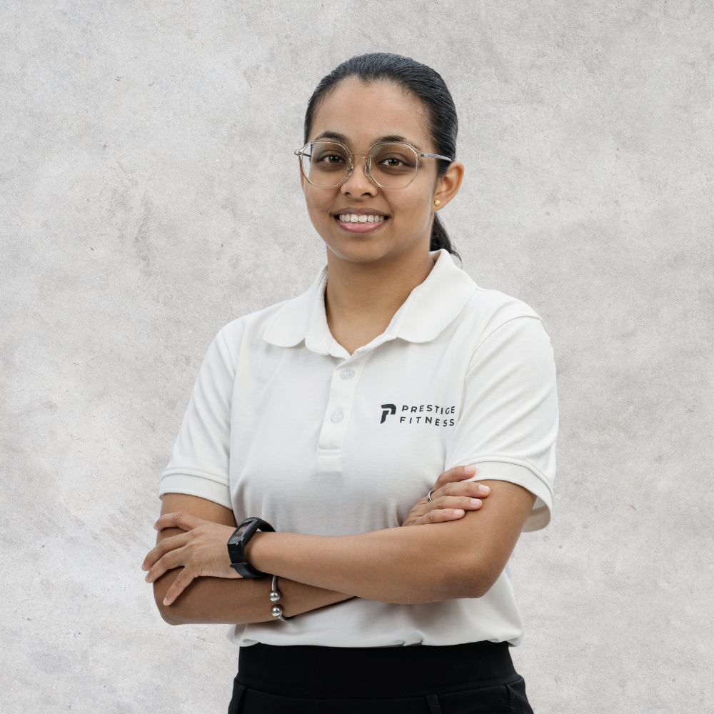Priya, personal trainer at Prestige Fitness Ipoh, coaching a senior client through safe strength and mobility exercises to improve balance, independence, and daily movement.