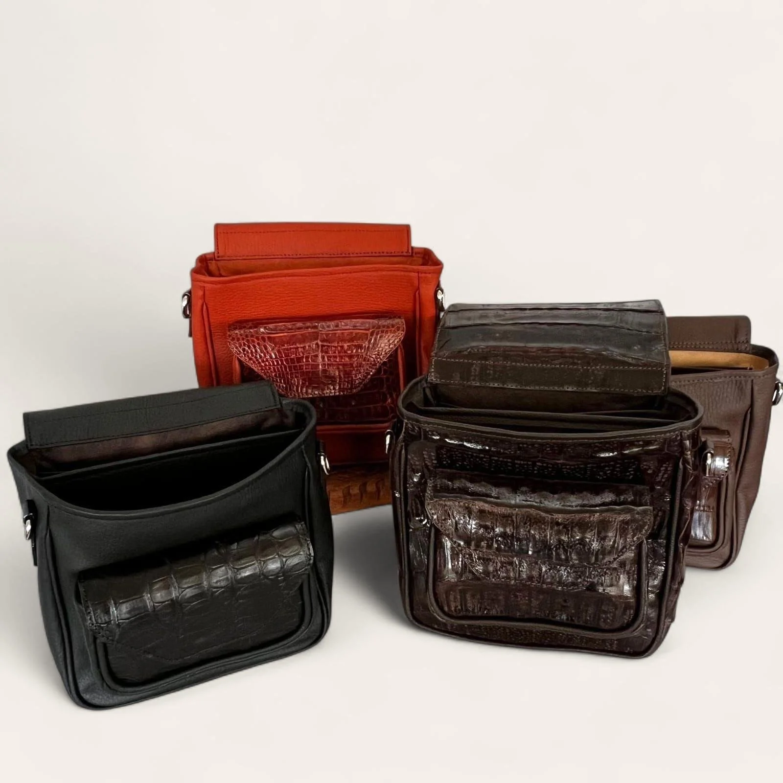 Summit & Selva handcrafted crocodile and paiche leather shotgun shell pouches displayed in multiple finishes