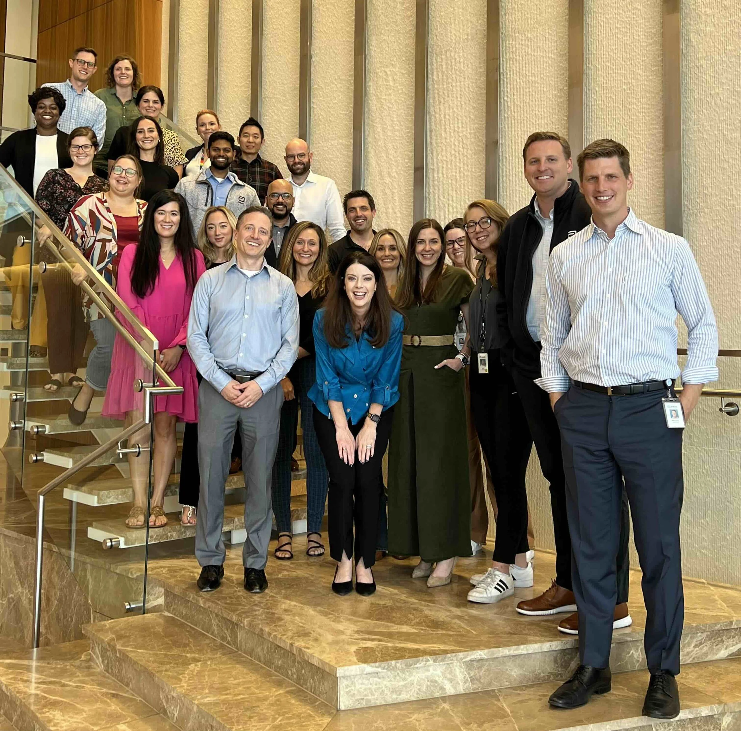 Group of women at a book signing event holding up copies of a book titled 'ALIFE ALIGNED' in a conference room
