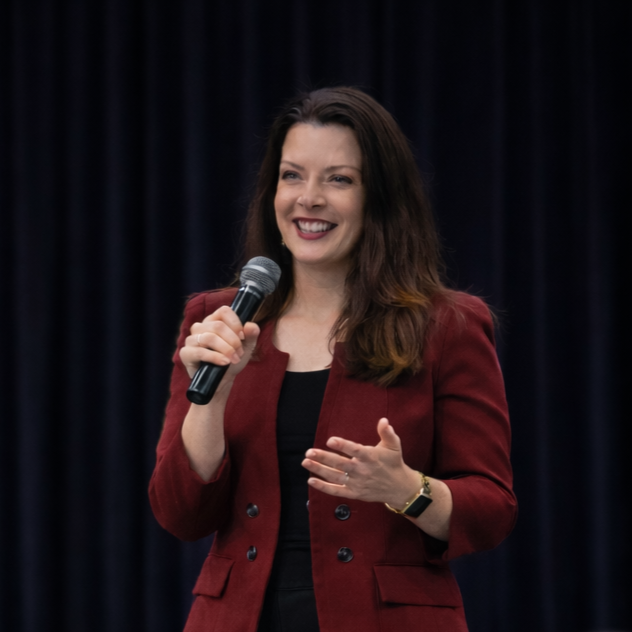 Three yellow balloons with smiley face designs on a textured gray wall.