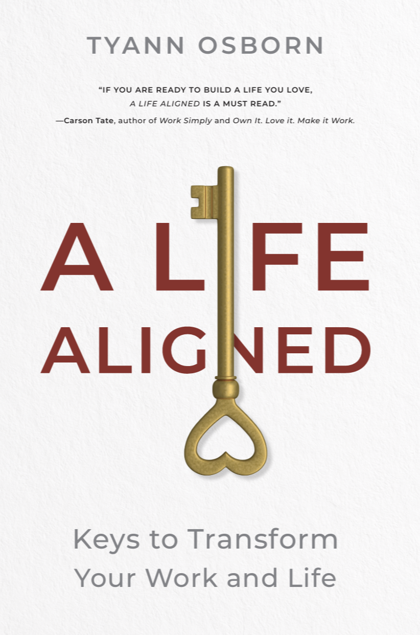 Book cover titled "A Life Aligned" with a gold key that has a heart-shaped bow, and text featuring the author's name, Tyann Osborn, and a quote about building a life you love.