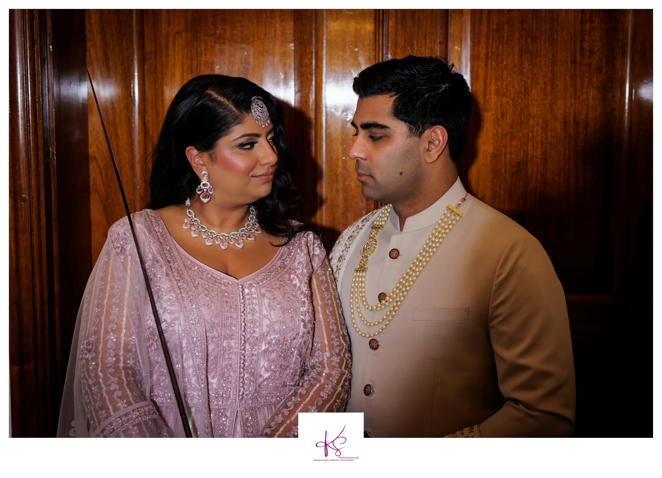 Couple in Indian dress and Sherwani looking at each other at photoshoot for their renewal of vows ceremony