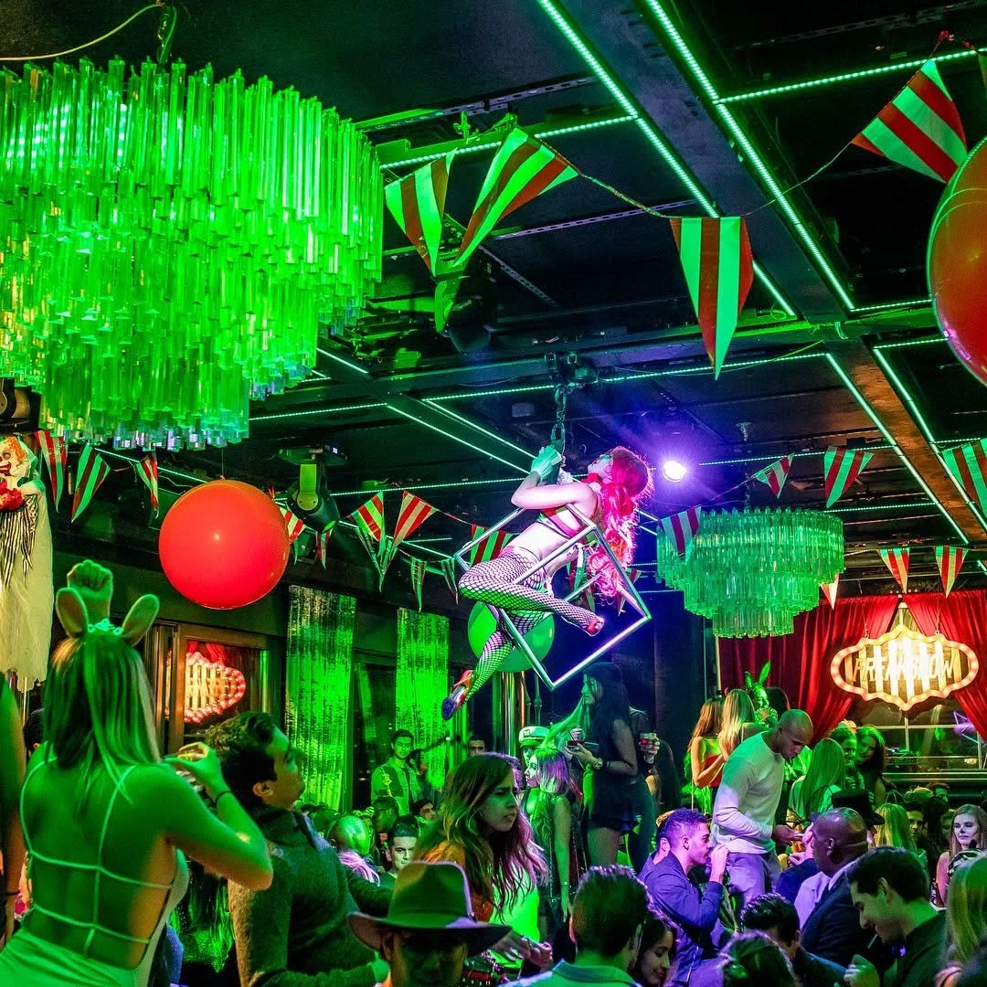 Costumed group posing in VIP section at PHD Halloween bash