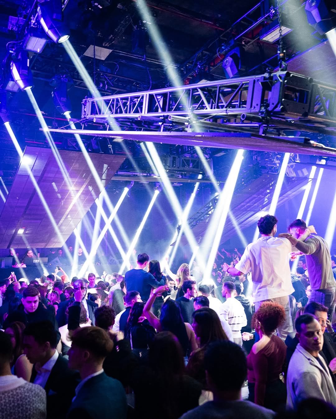 Costumed guests dancing under lasers at NEBULA NYC