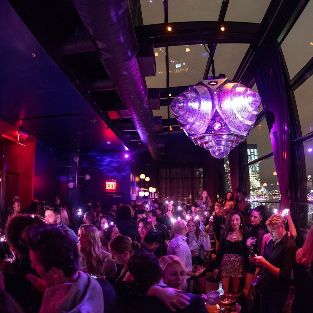 Glamorous Halloween attendees posing for photos inside venue