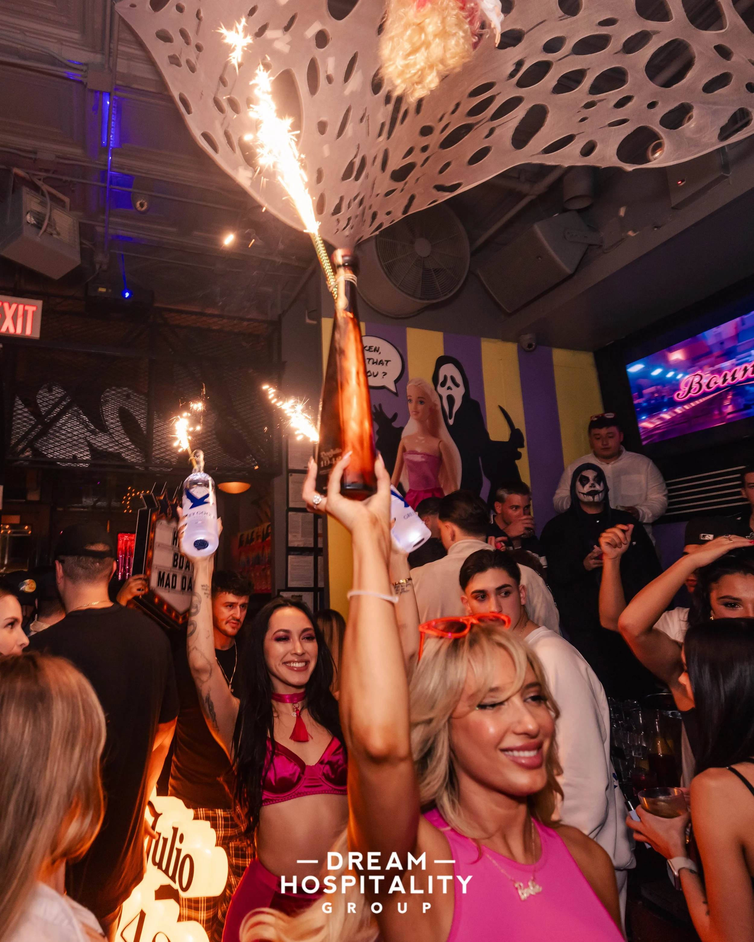 Costumed partygoers enjoying the upscale lounge vibe at T-Squared