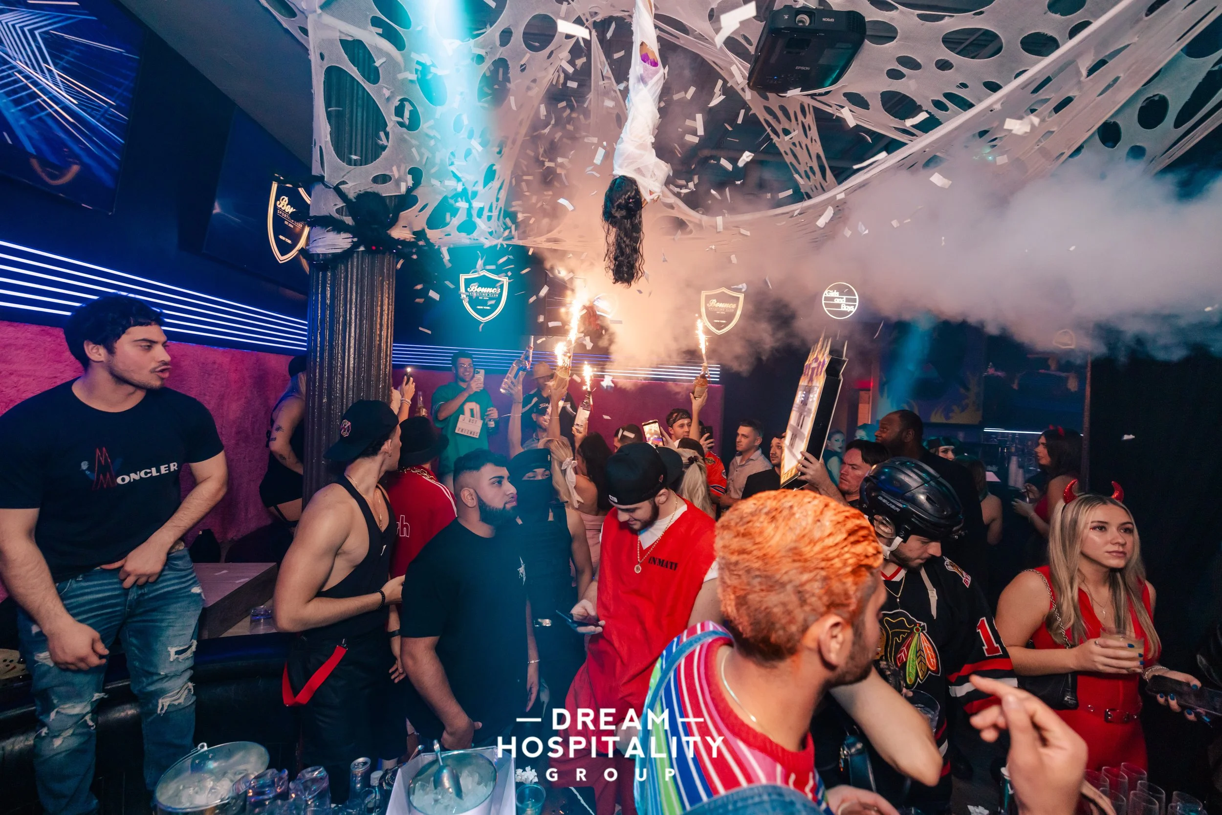 Group celebrating with drinks at the Bounce pop-up Halloween event