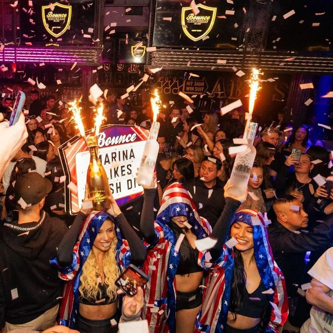 T-Squared Social NYC interior – upscale sports bar and lounge with vibrant lighting, stylish seating, and large screens.