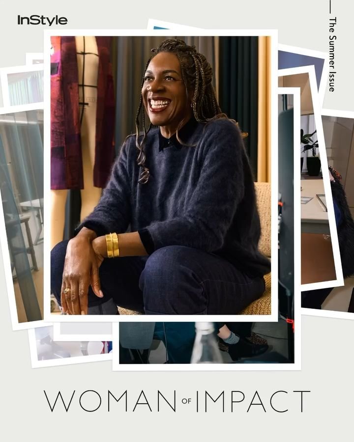 Ngozi Okaro with long braided hair poses in a navy sweater and jeans, smiling