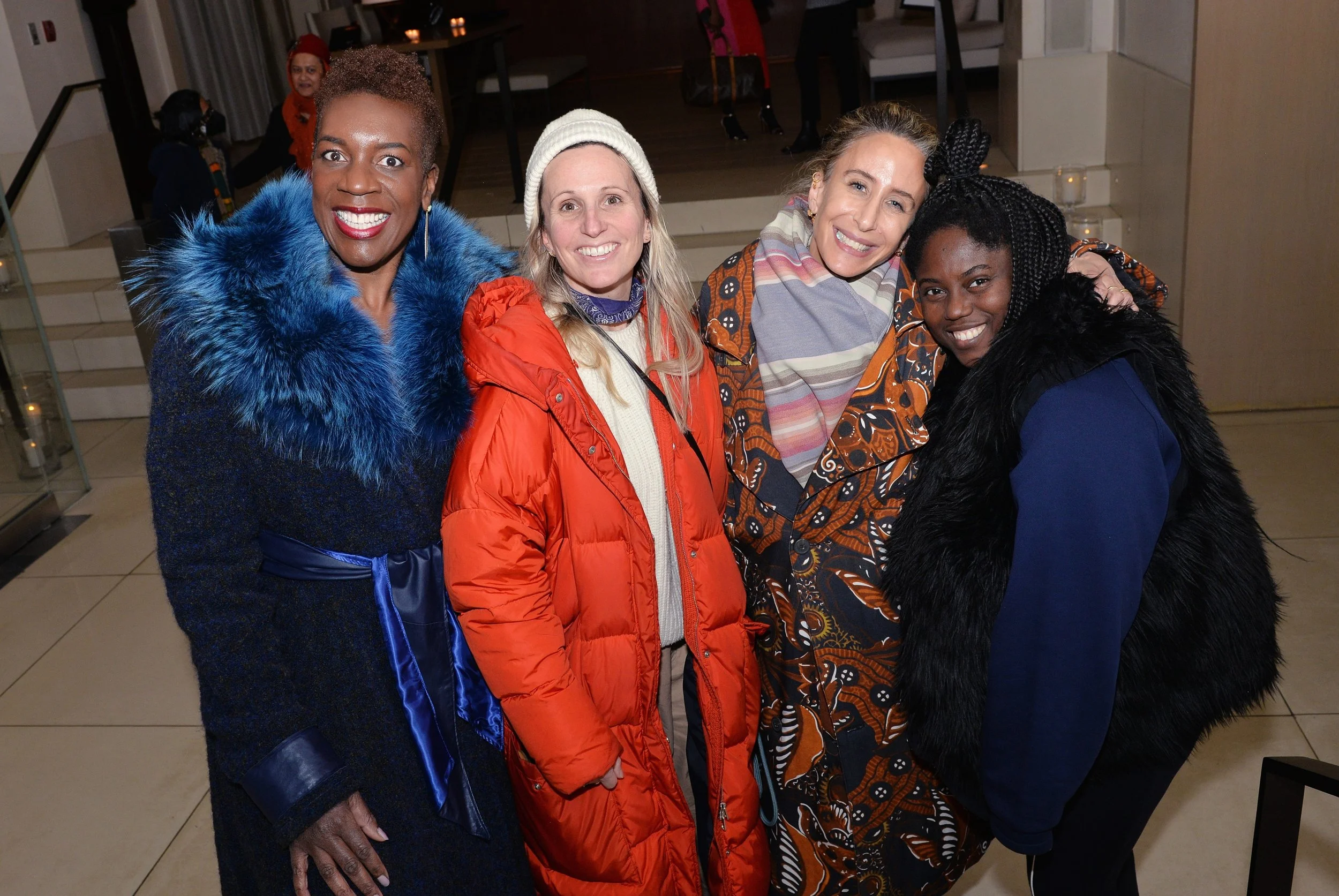 Ngozi Okaro, Dana Davis, Mara Hoffman, and  Abrima Erwiah post together for a photo, each wearing winter jackets