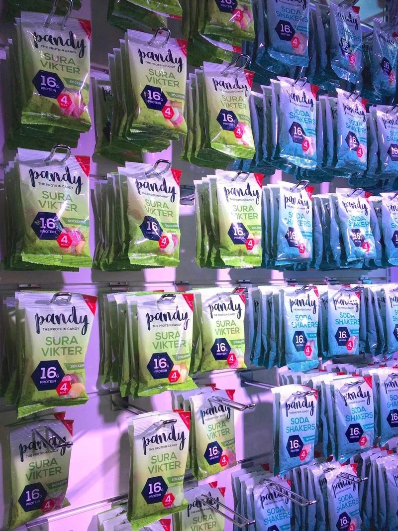 Display of Pandy Sura Vikter and Soda Shakers protein candies on store shelves.