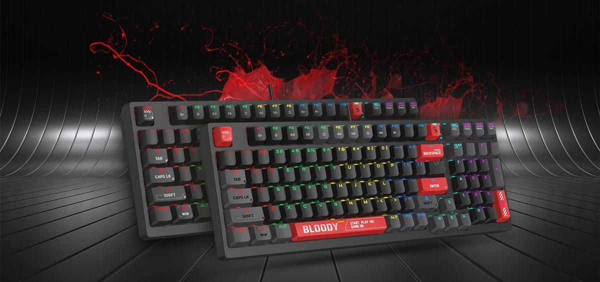 A gaming keyboard with RGB backlit keys and a custom red spacebar with the word BLOODY and gaming commands written on it, set against a futuristic background with red lightning effects.