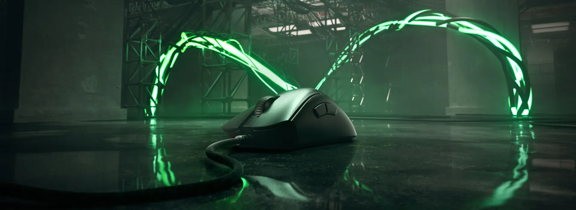 A computer mouse with a cord lying on a reflective surface in front of a neon green, futuristic, illuminated tunnel structure.