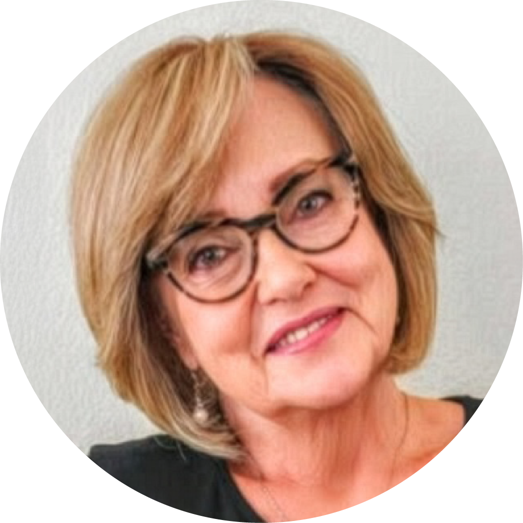 A woman with blonde hair, glasses, and a black top smiling at the camera.