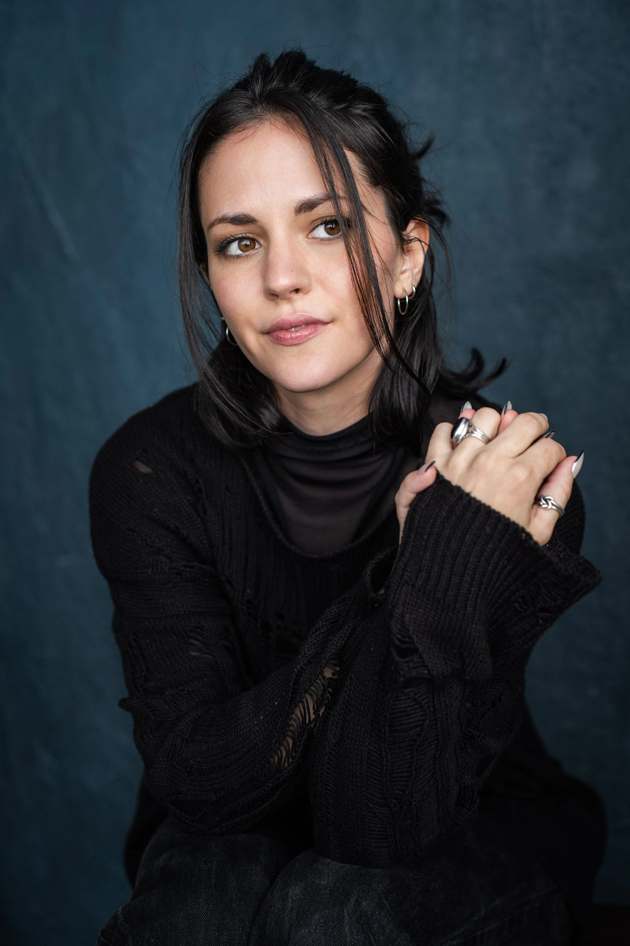 a person with dark hair looking slightly to the right