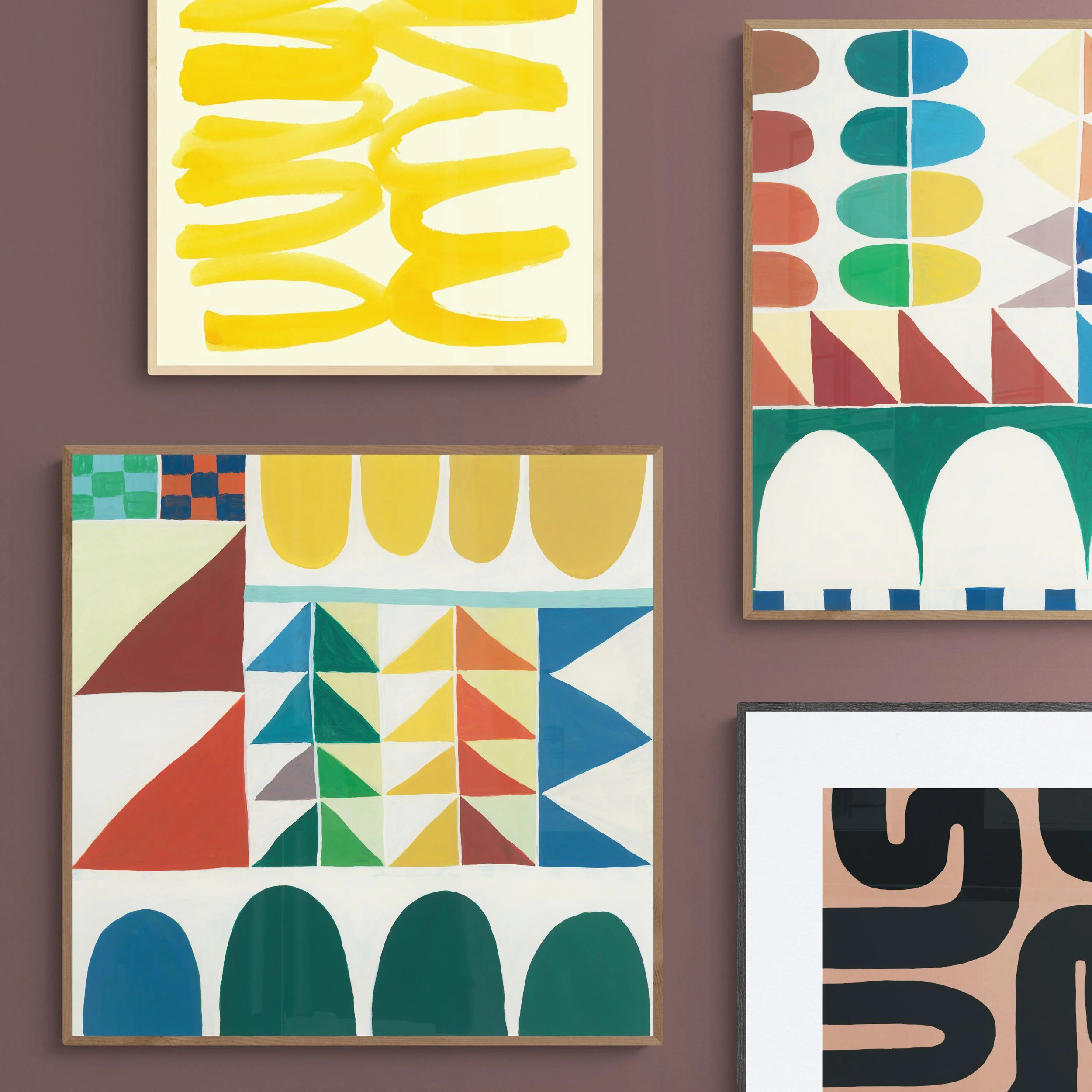 Four colorful abstract paintings with geometric and organic shapes on a brown wall.