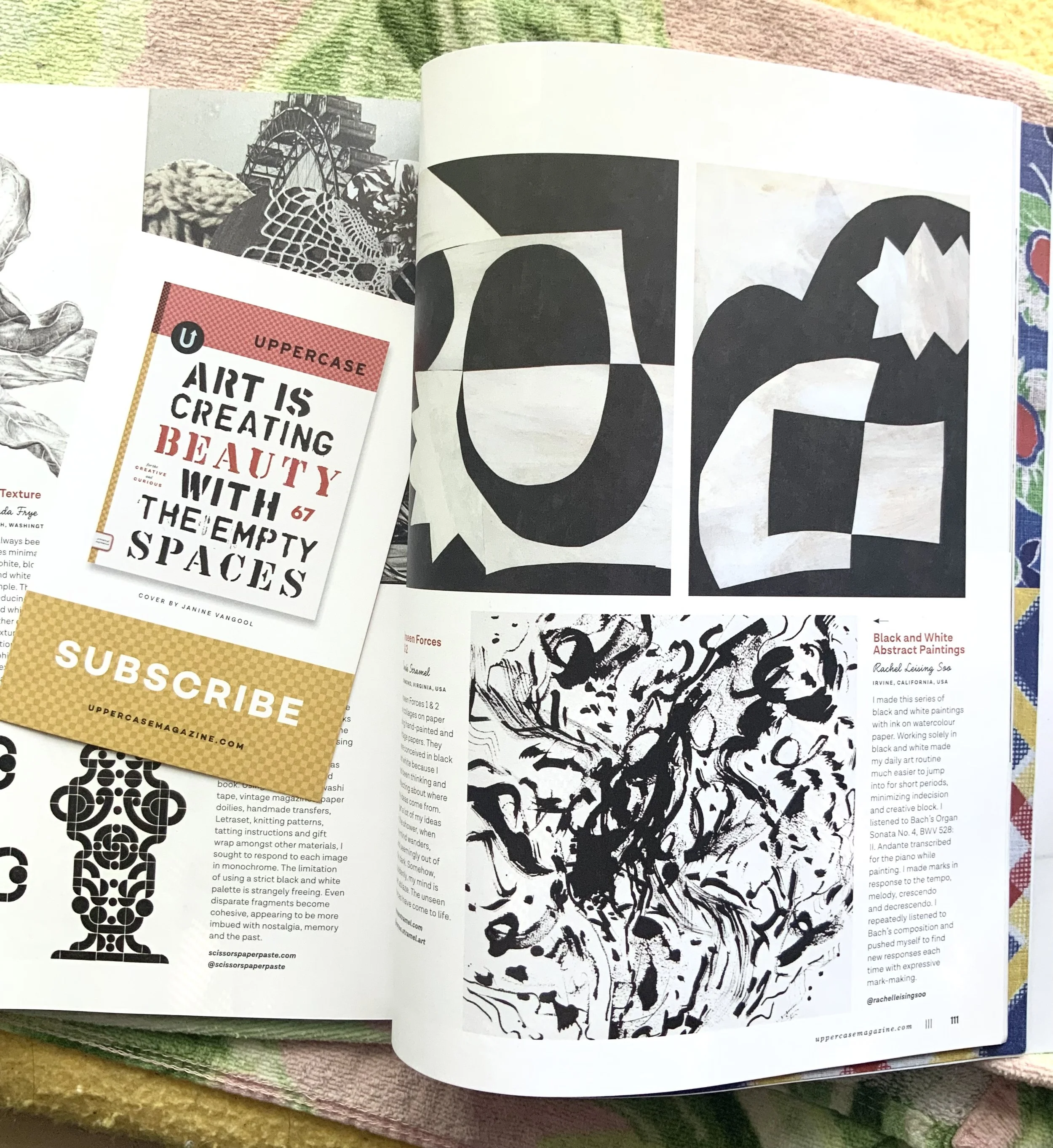 Open magazine featuring black and white abstract paintings, black and white graphic patterns, and an art quote card with a pink, black, and white design.