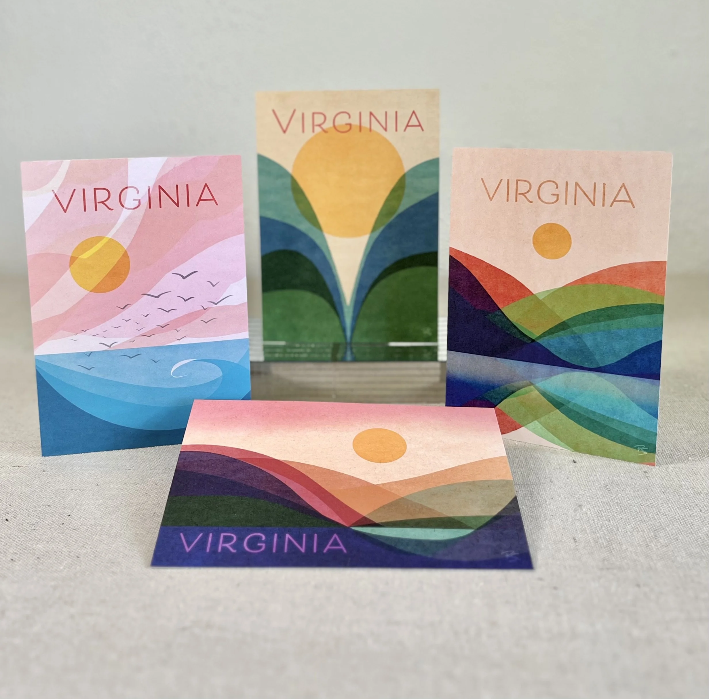 Four colorful cards with landscape and sunset designs, each featuring the word 'VIRGINIA' in uppercase letters.