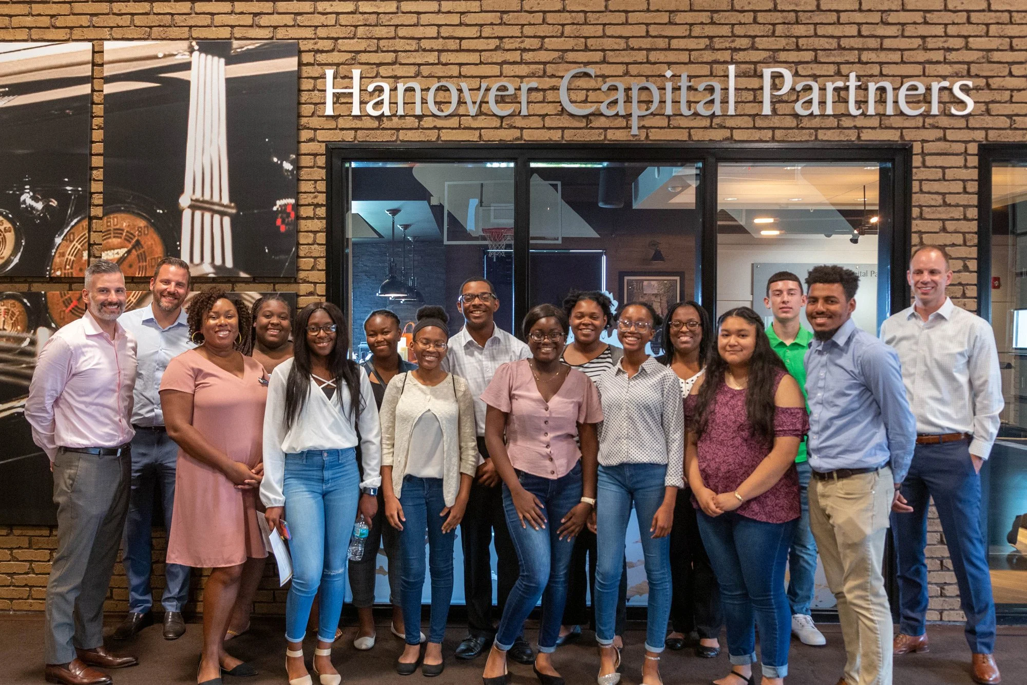Group of students from Elevation Scholars Program and Hanover Capital leaders shown at Hanover Capital Partners Headquarters.