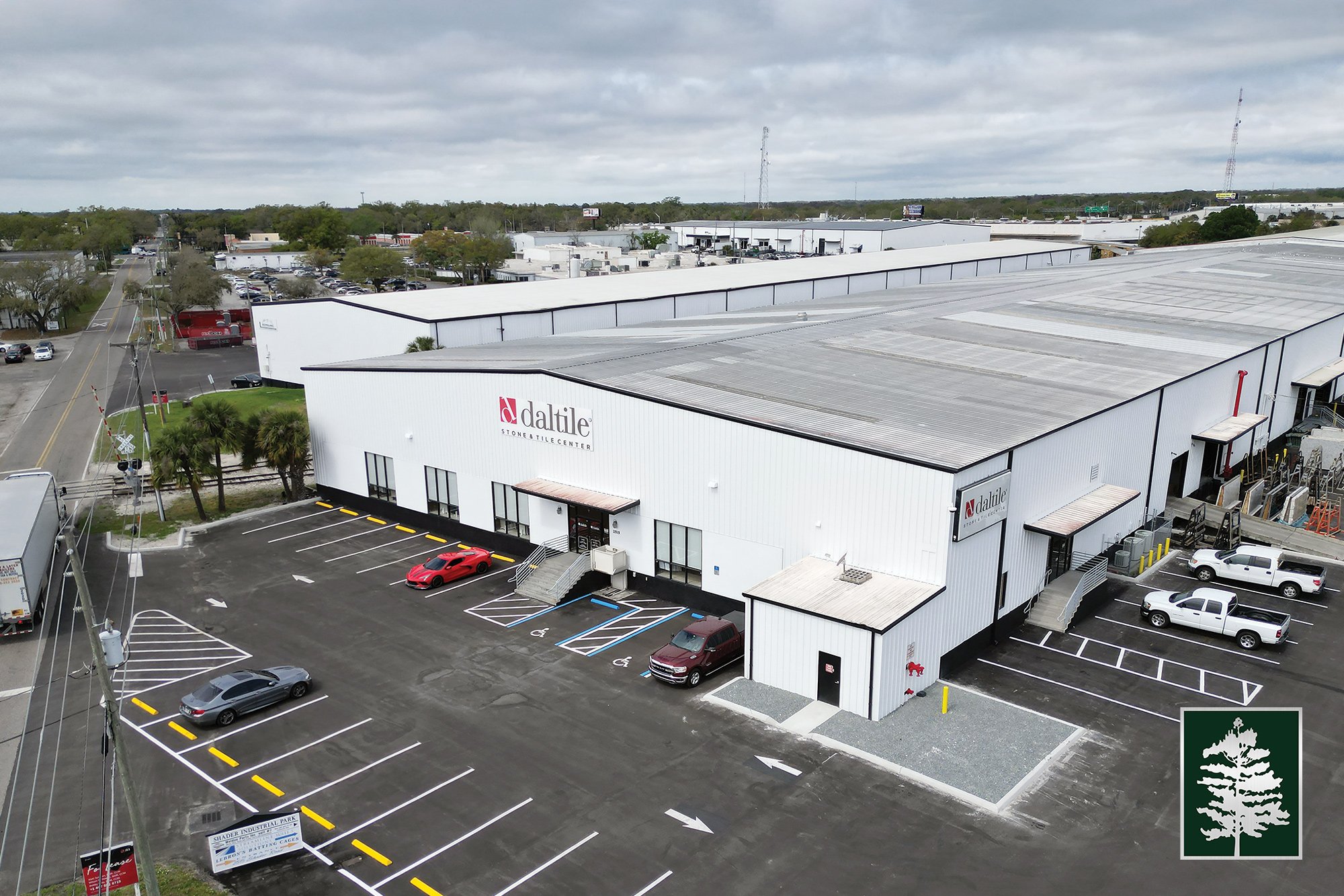 Aerial view of Daltile stone and tile center building with parking lot and surrounding industrial area