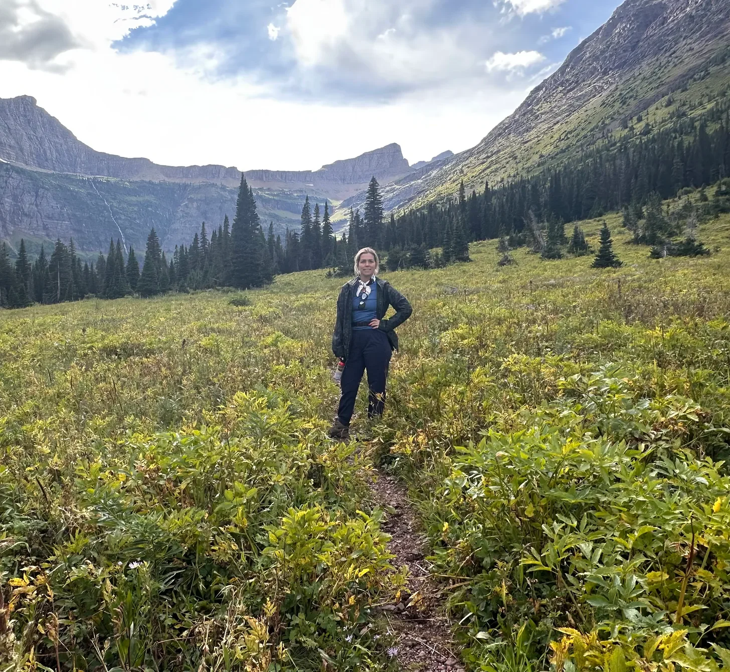 Hayley Dickson in a field with mountain and trees in the background