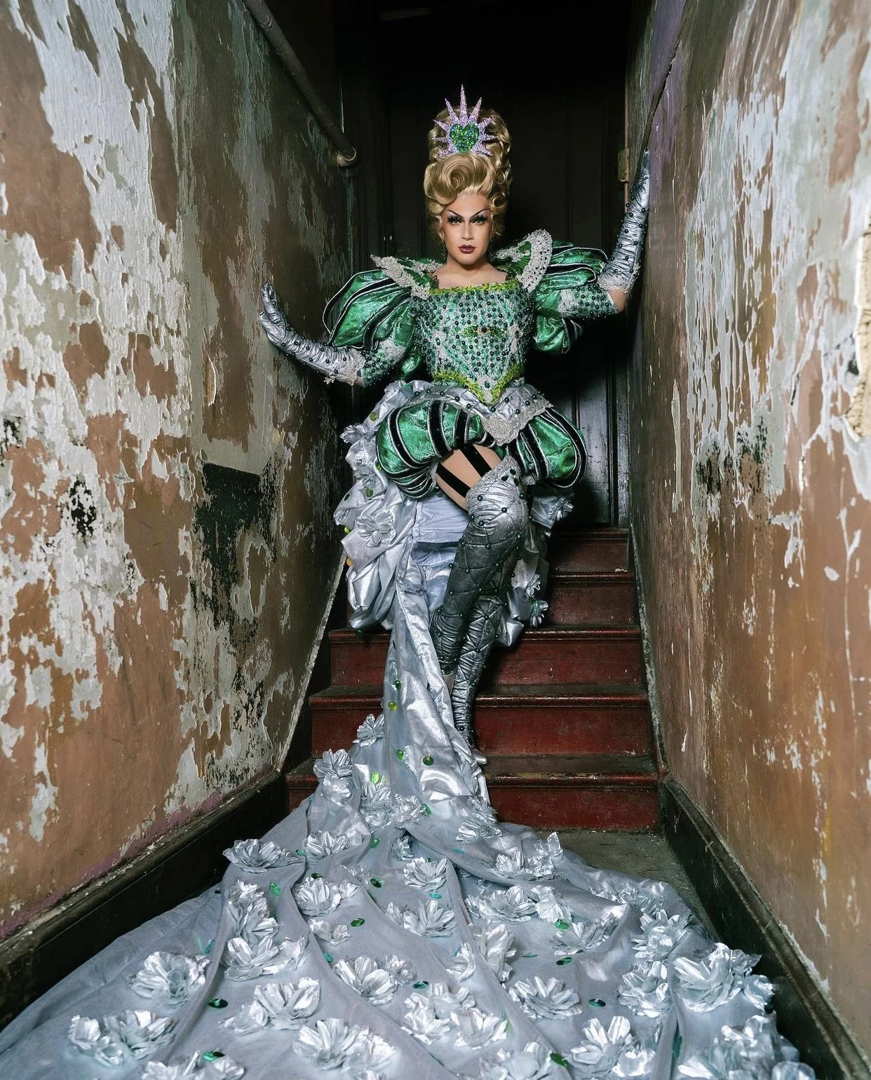 Rosé from RuPaul's Drag Race poses in an elaborate dress in the hallway at Gymnopedie