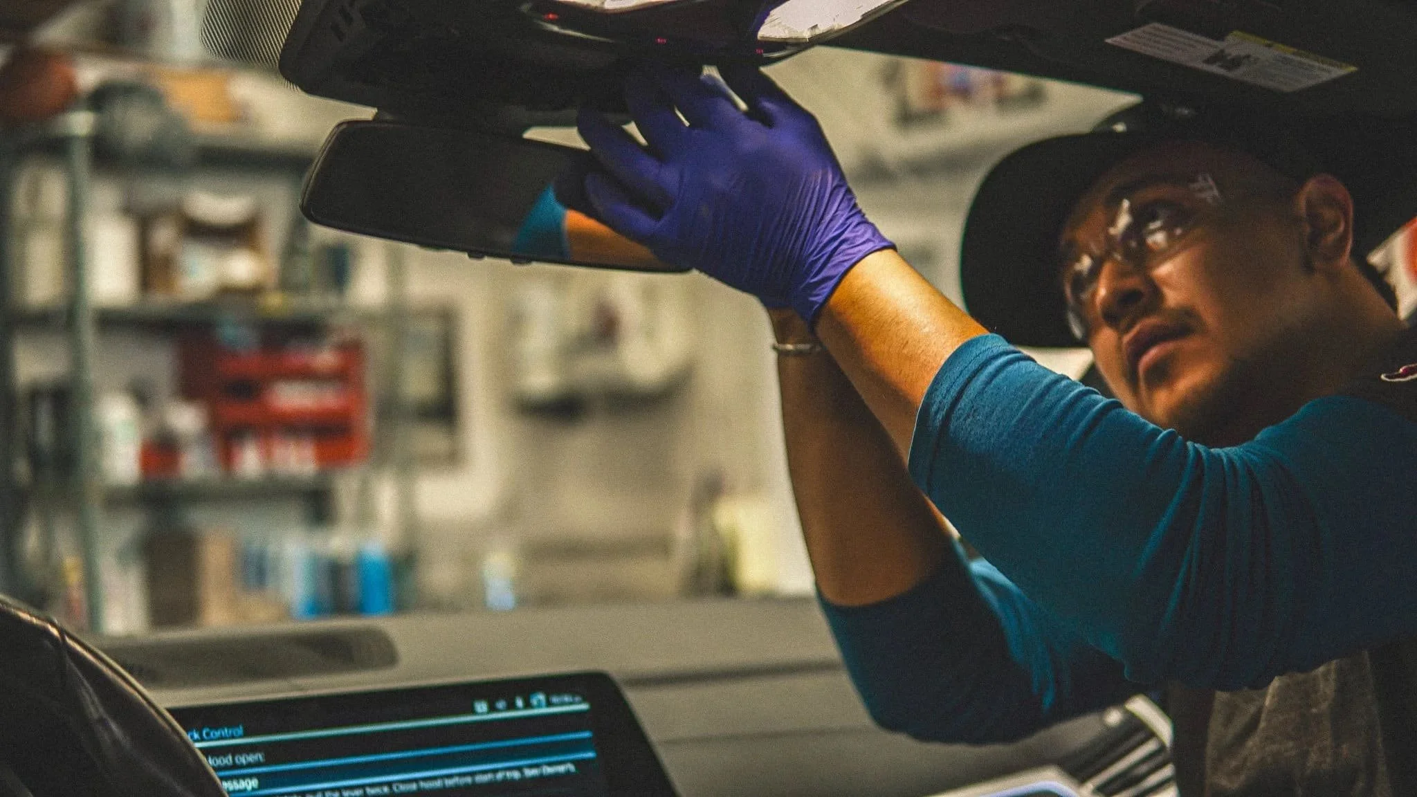 Technician Working Carefully on Car's Windshield Electronics