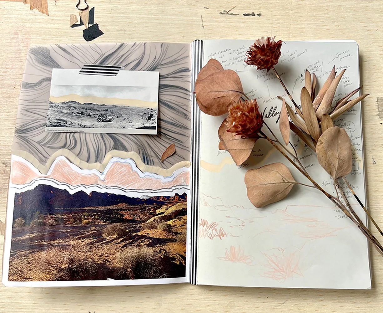 An open journal or planner with glued-in photos of landscapes on the left page and handwritten notes on the right page. Dried leaves and flowers are arranged on the right page.