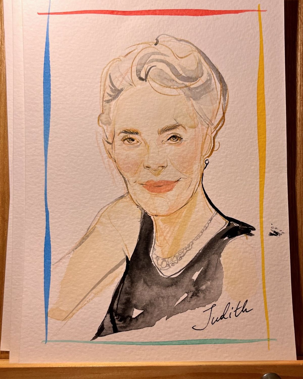 A watercolor portrait of a woman with short hair and a necklace, signed 'Judith', surrounded by colorful lines.