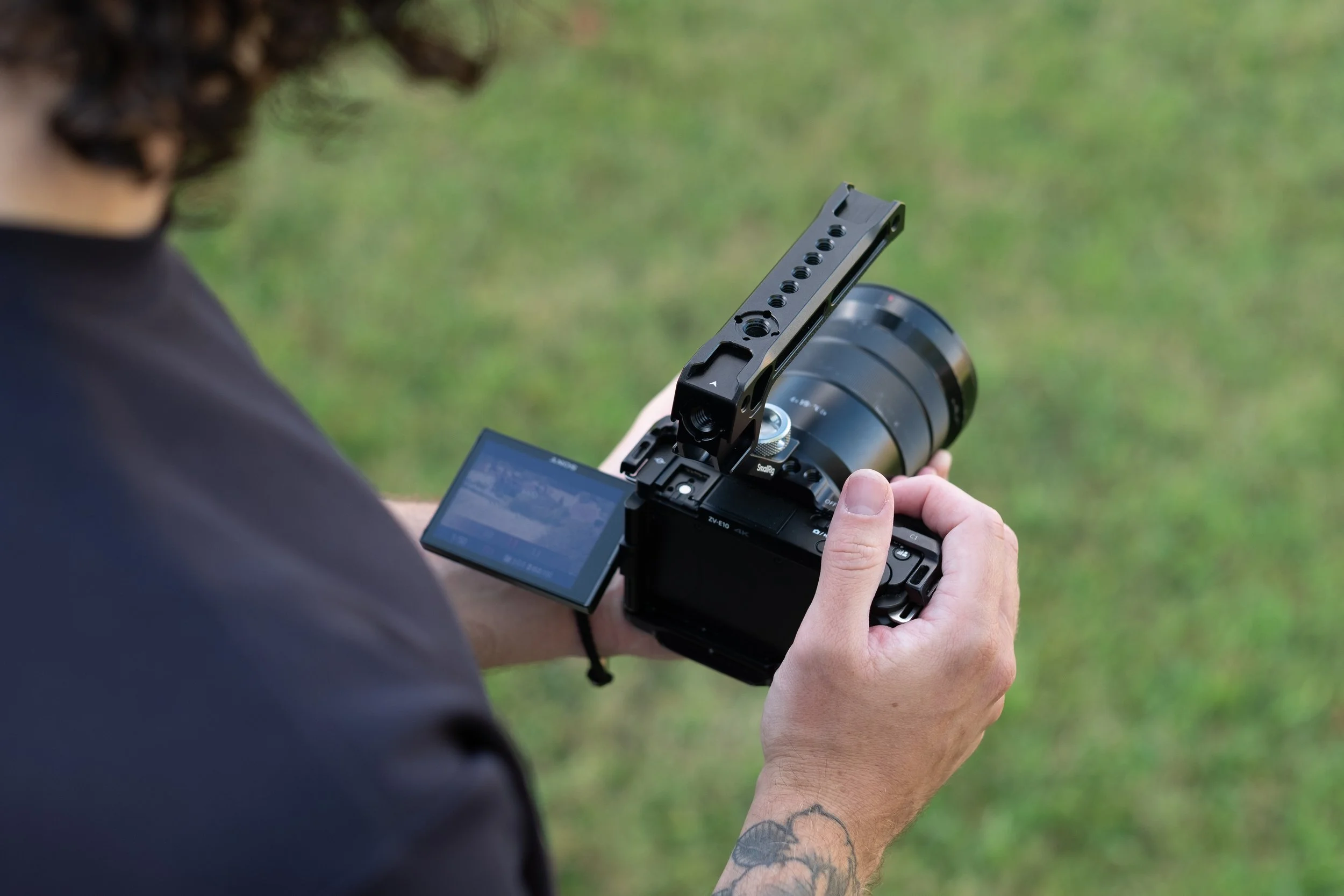 man holding a camera in a field