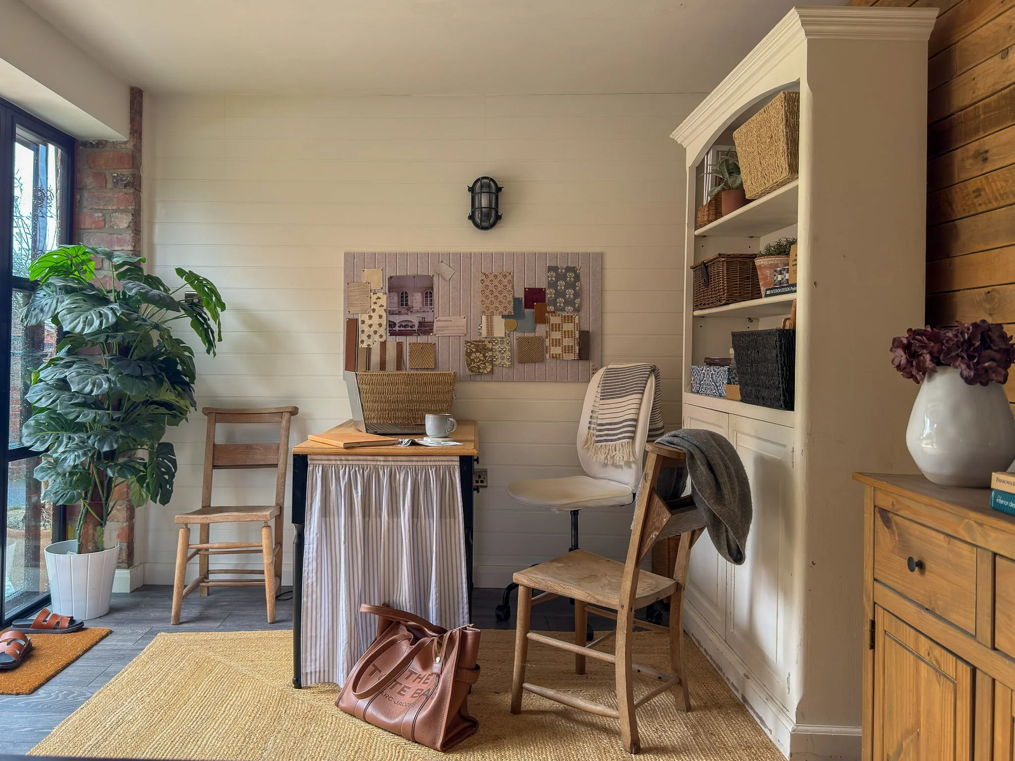 Warm, layered home office with natural materials and timber shelving, designed by Fay Allison Interior Design in Derbyshire.