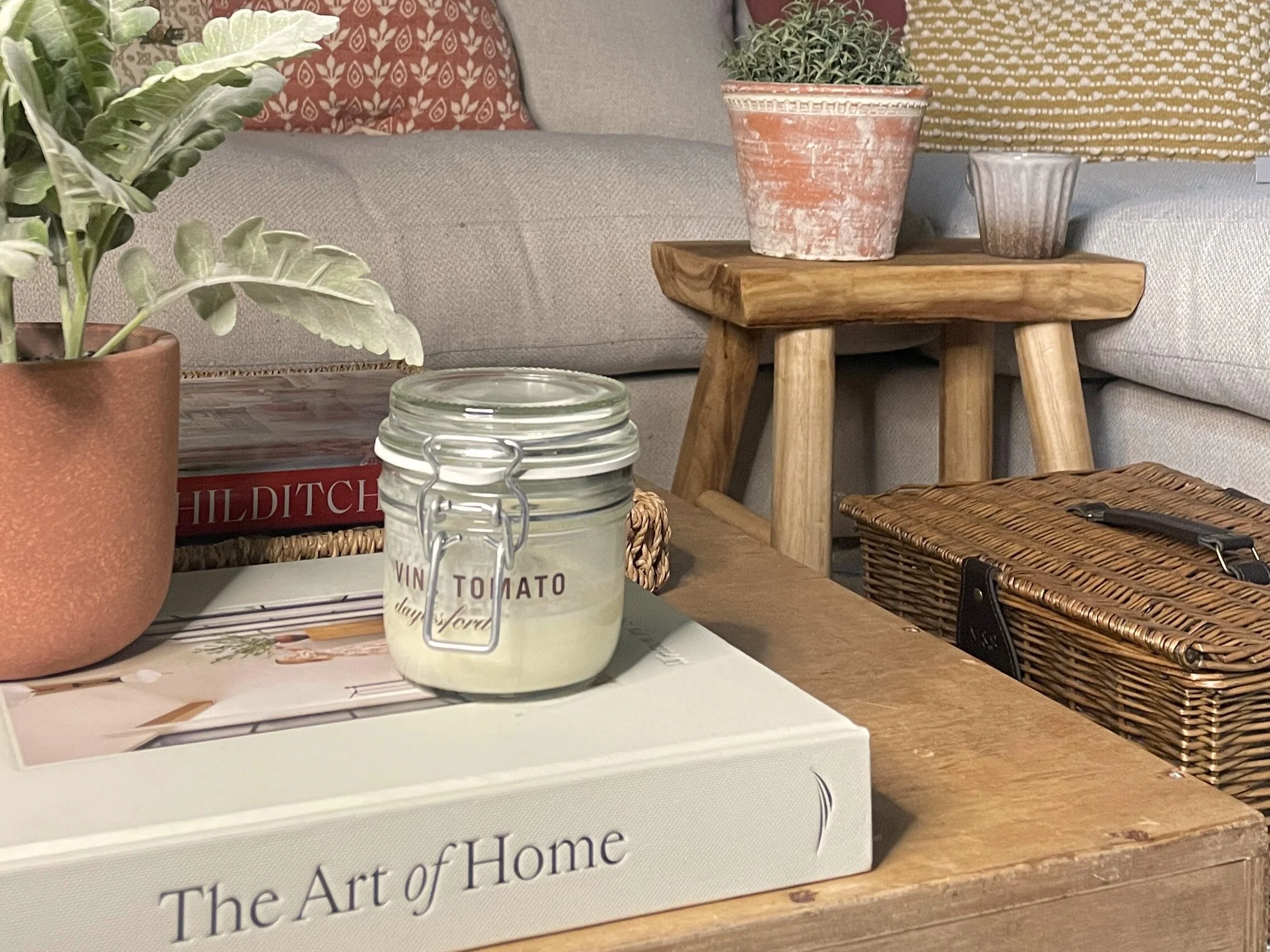 Styled shelf detail with a potted plant, books and rustic accessories
