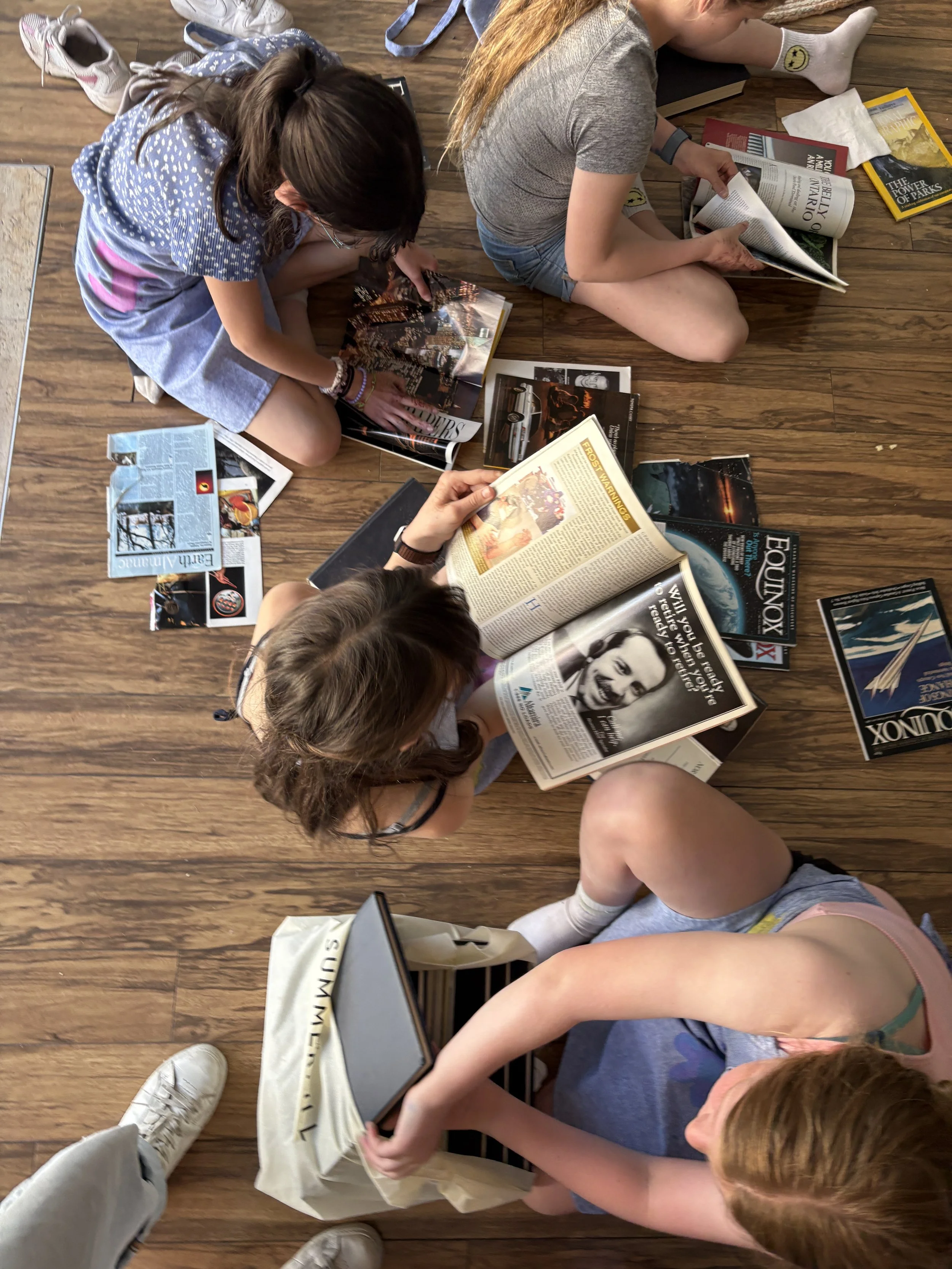 Kids flipping through magazines looking for images to add to their collages and junk journals