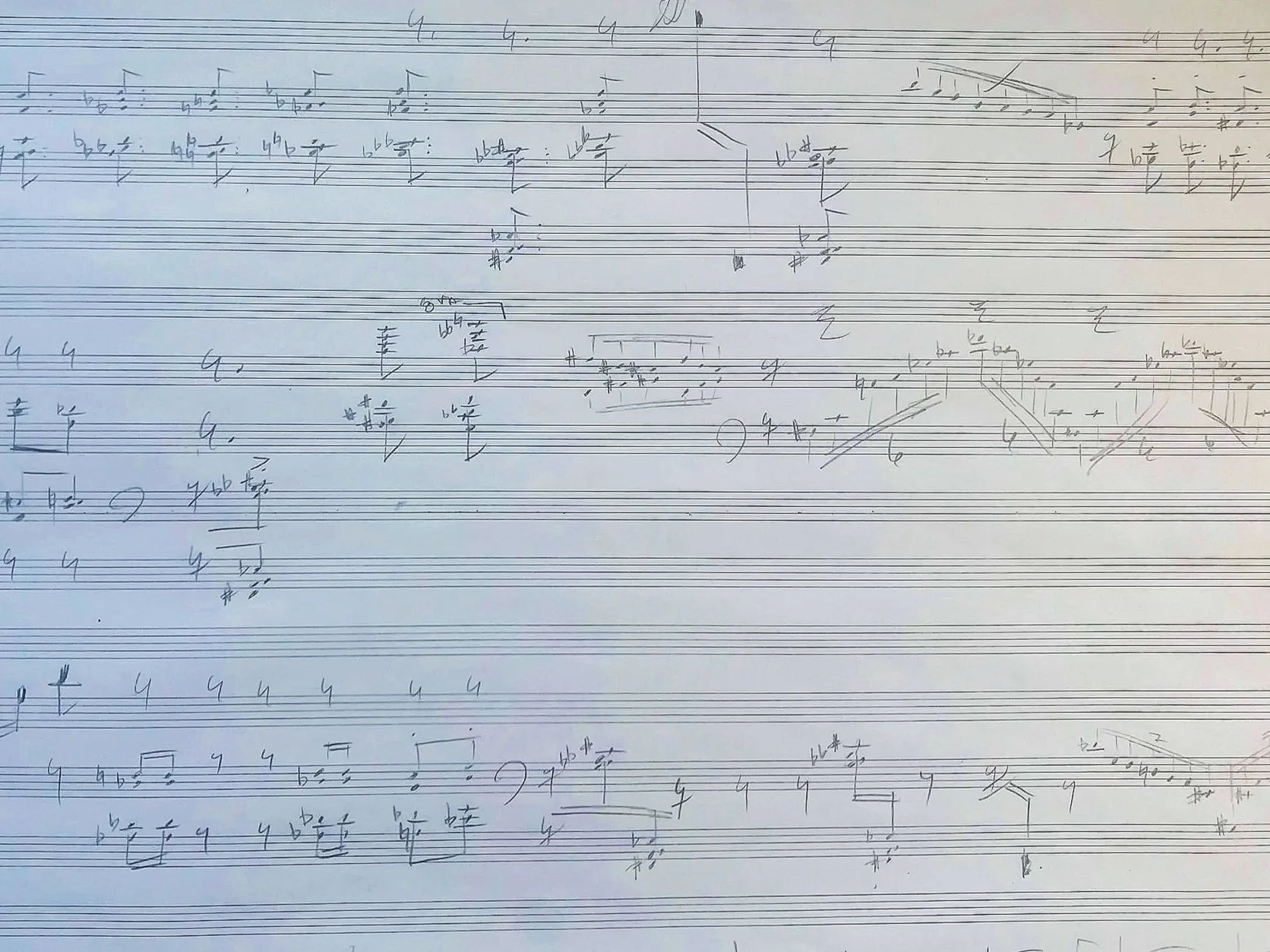 Sheet music with handwritten notes and musical notation. John Aylward's creative process.