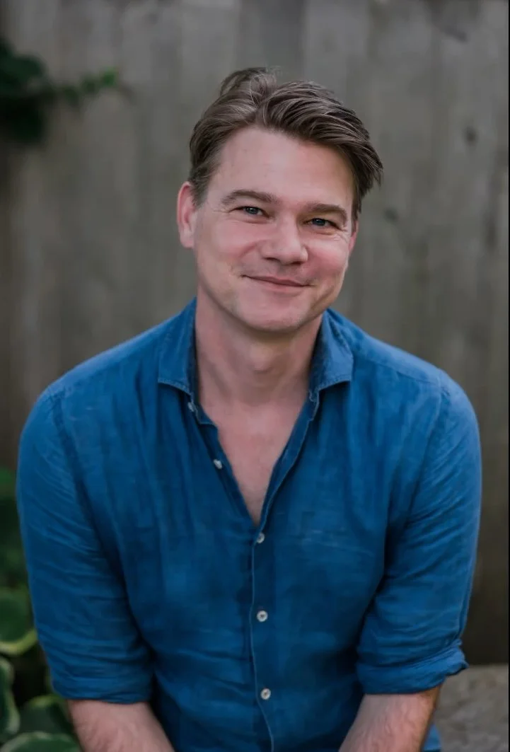 Portrait of composer John Aylward, known for his innovative contemporary music and explorations of musical time, identity, and memory.