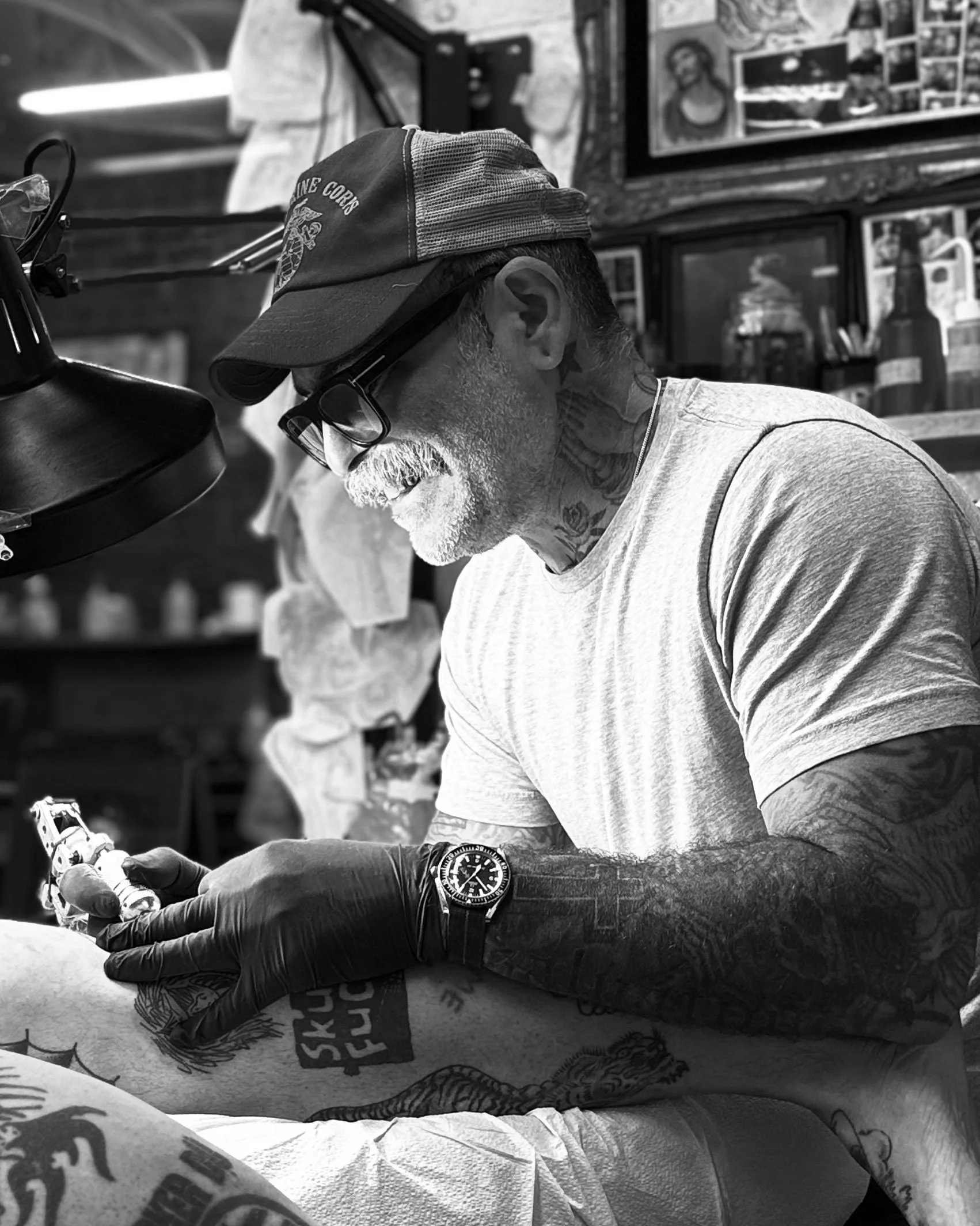 Black and white close-up of a man with long hair and a full beard, staring intently at the camera.